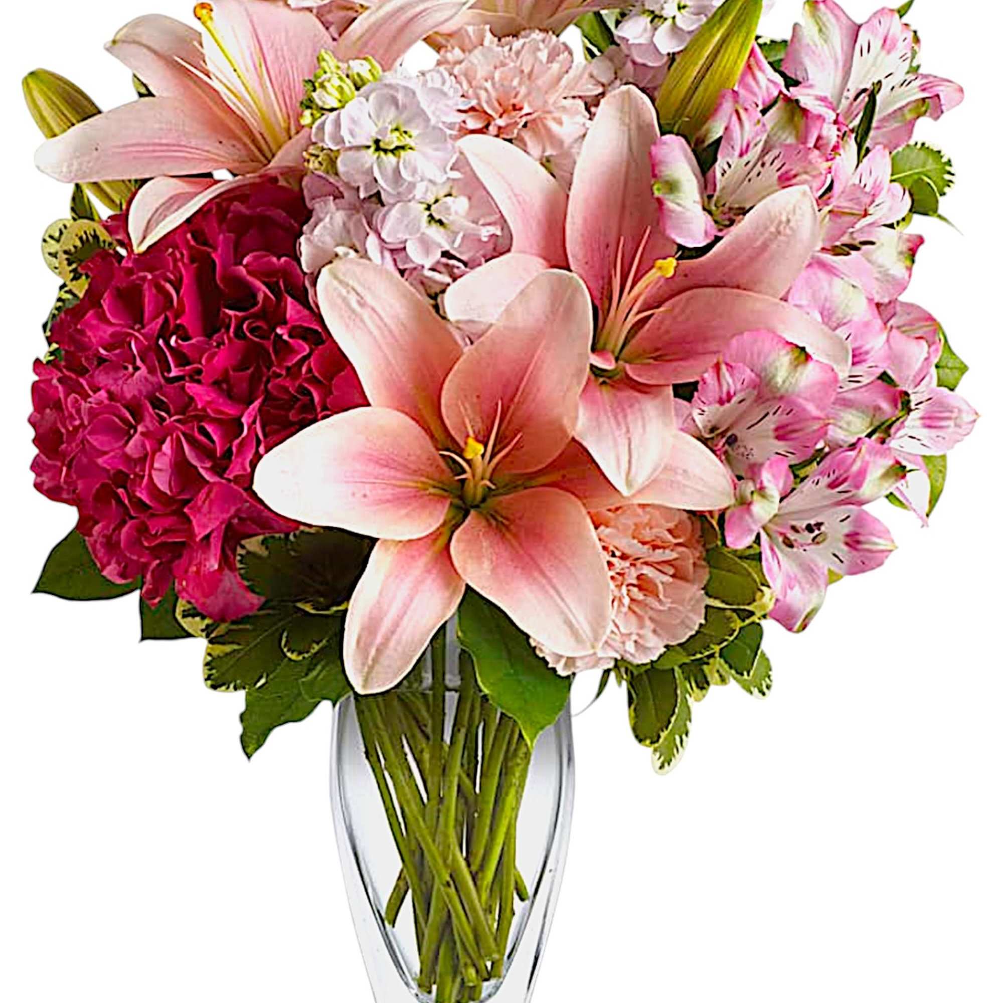 Pink lilies and mixed blooms arranged in a clear glass vase
