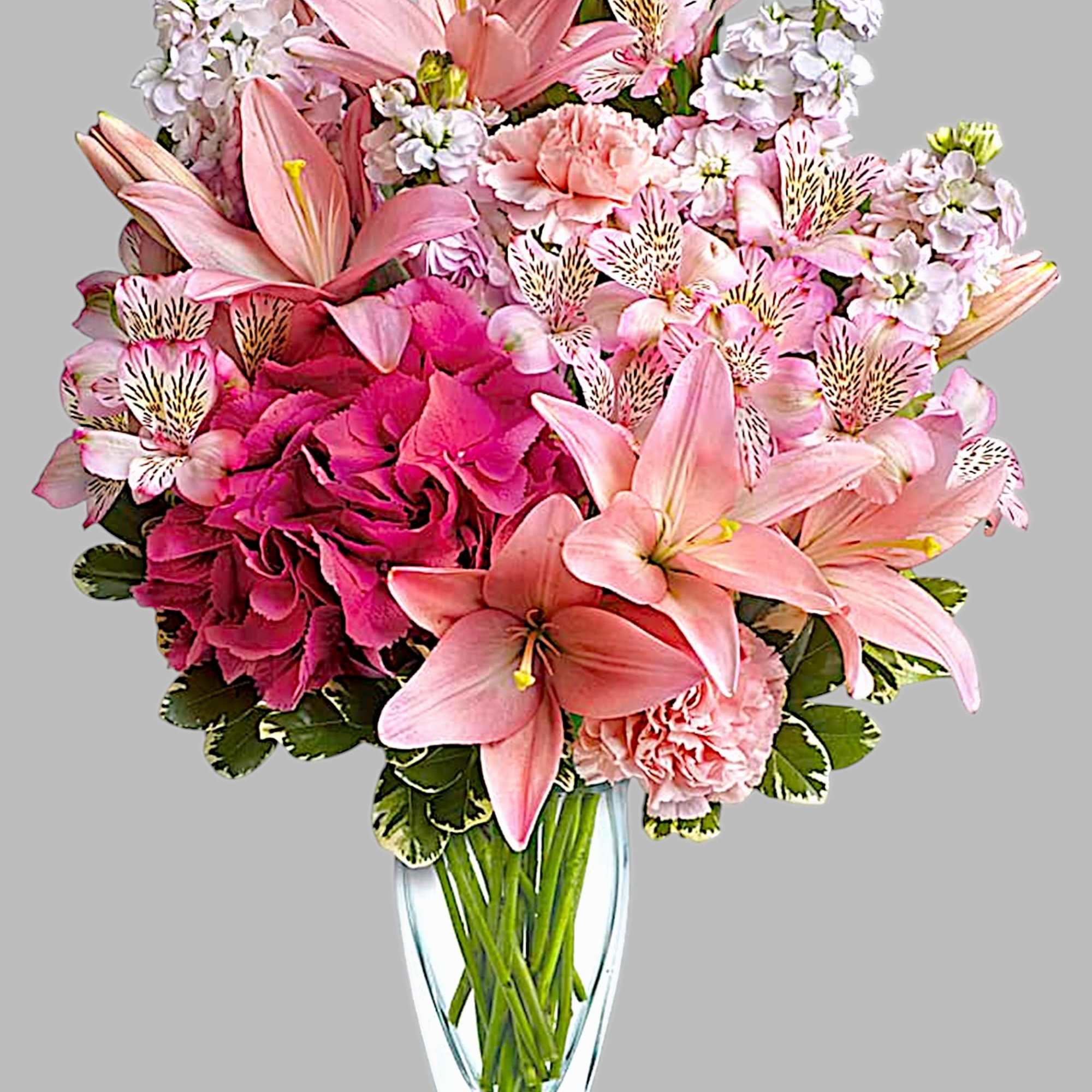 Pink lilies and carnations in a clear glass vase, photo 4 of 4