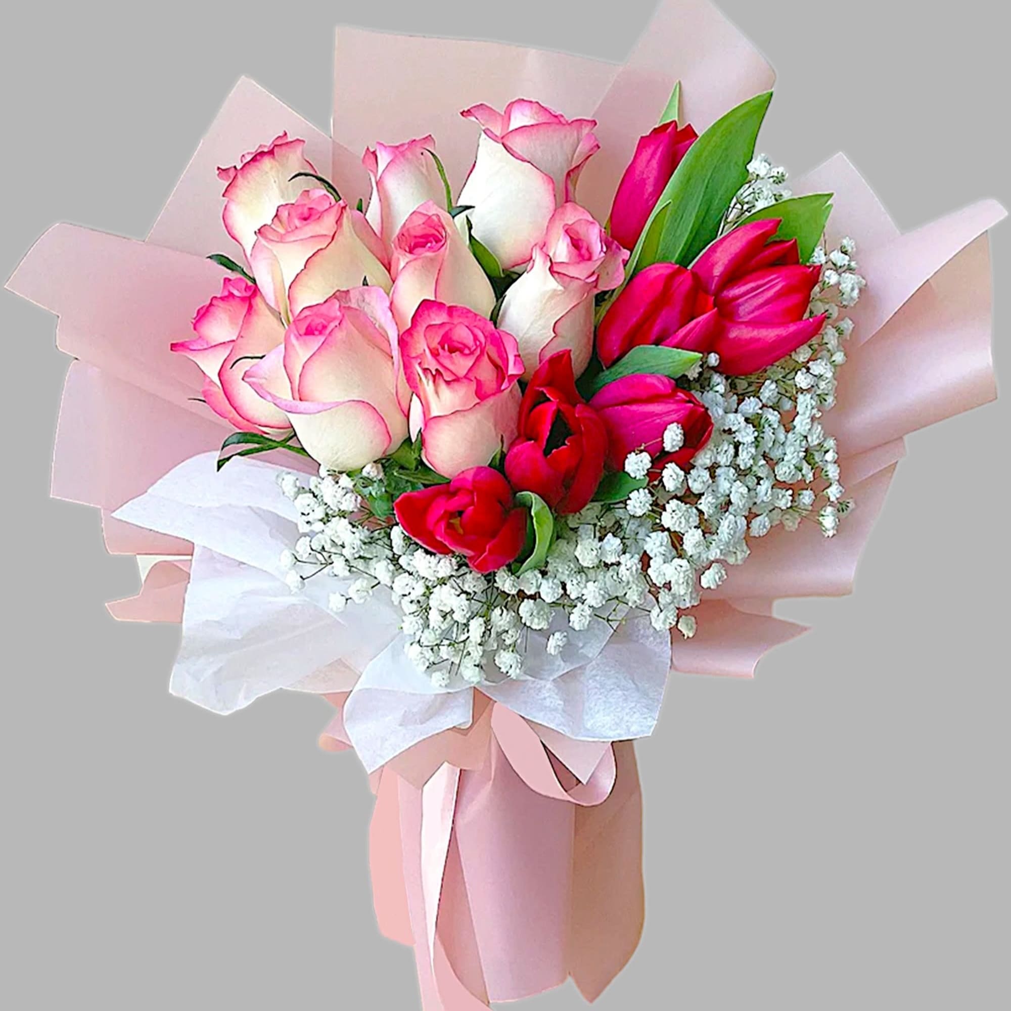 Bouquet of pink and white roses with baby's breath in pastel wrapping