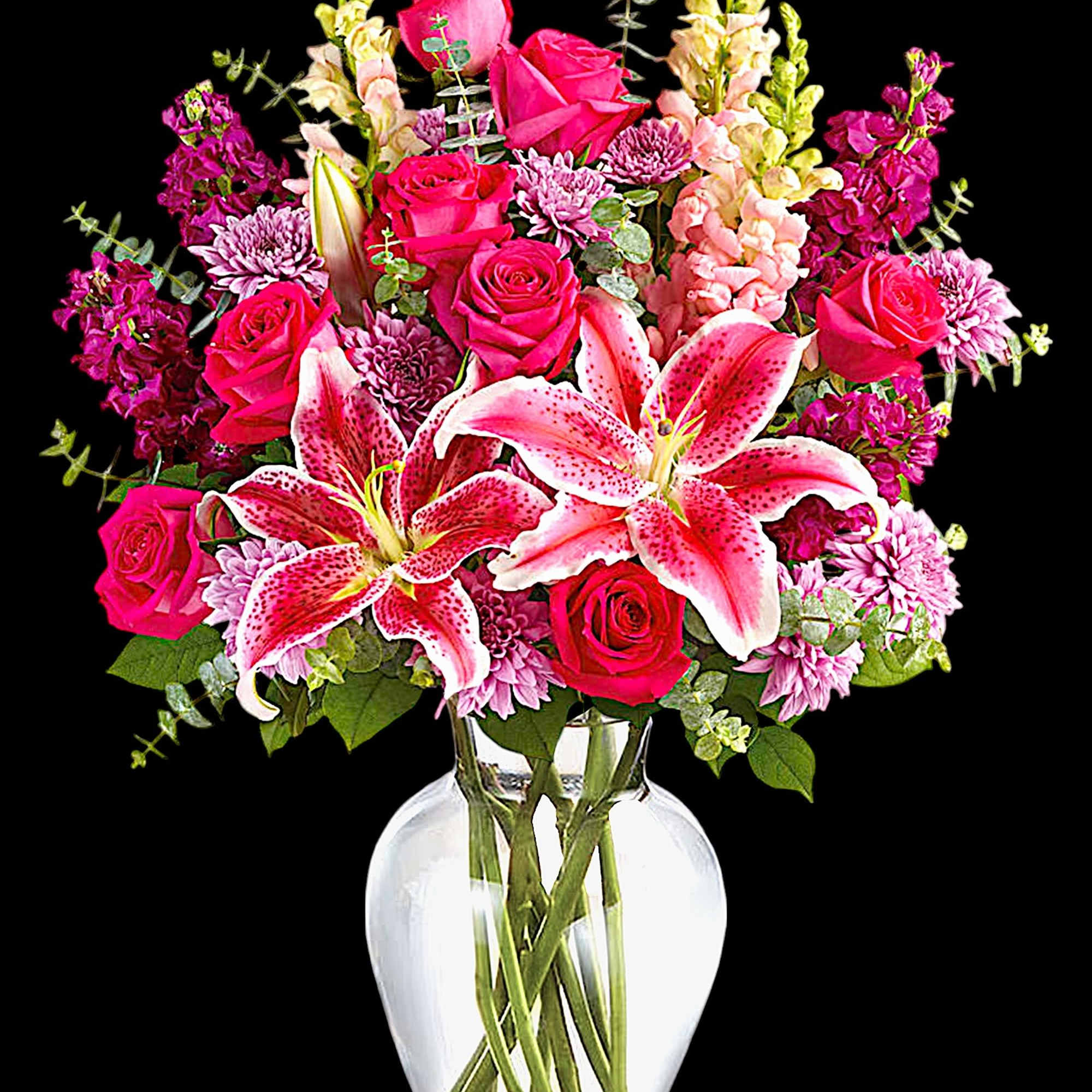Pink roses and lilies arranged in a clear glass vase, photo 3 of 4