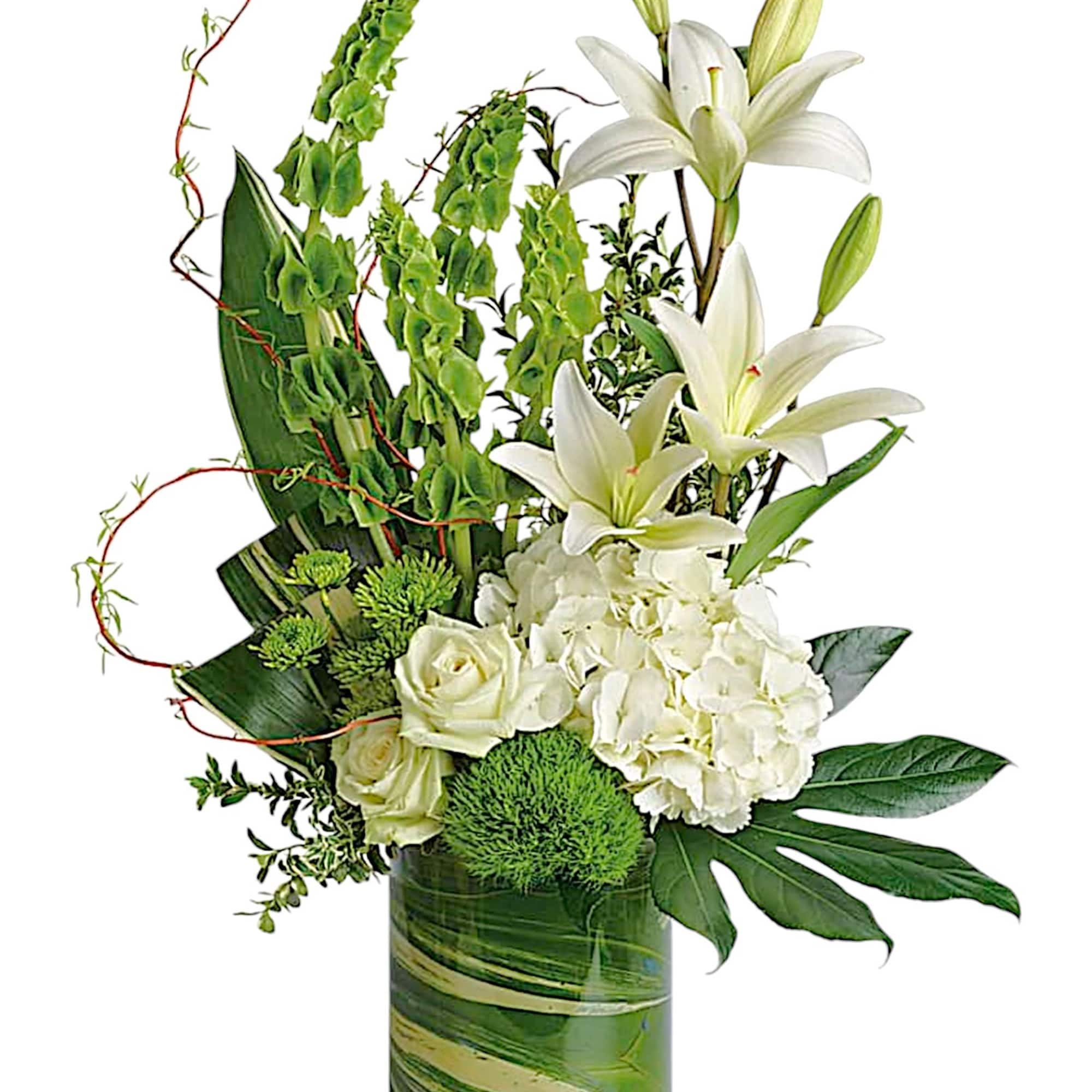 White lilies and roses in a green glass vase with green accents