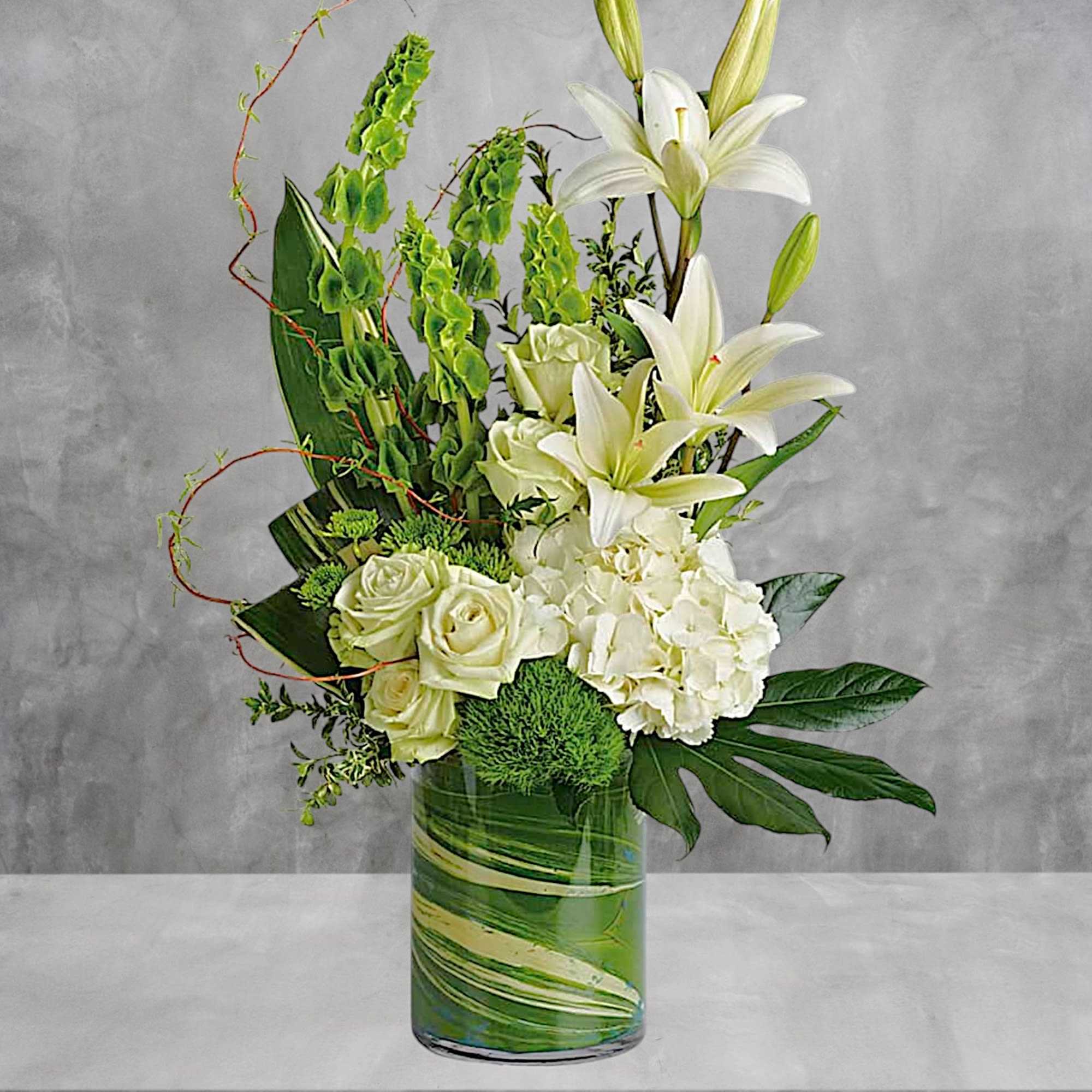 White lilies and roses arranged in a green glass vase, photo 2 of 4