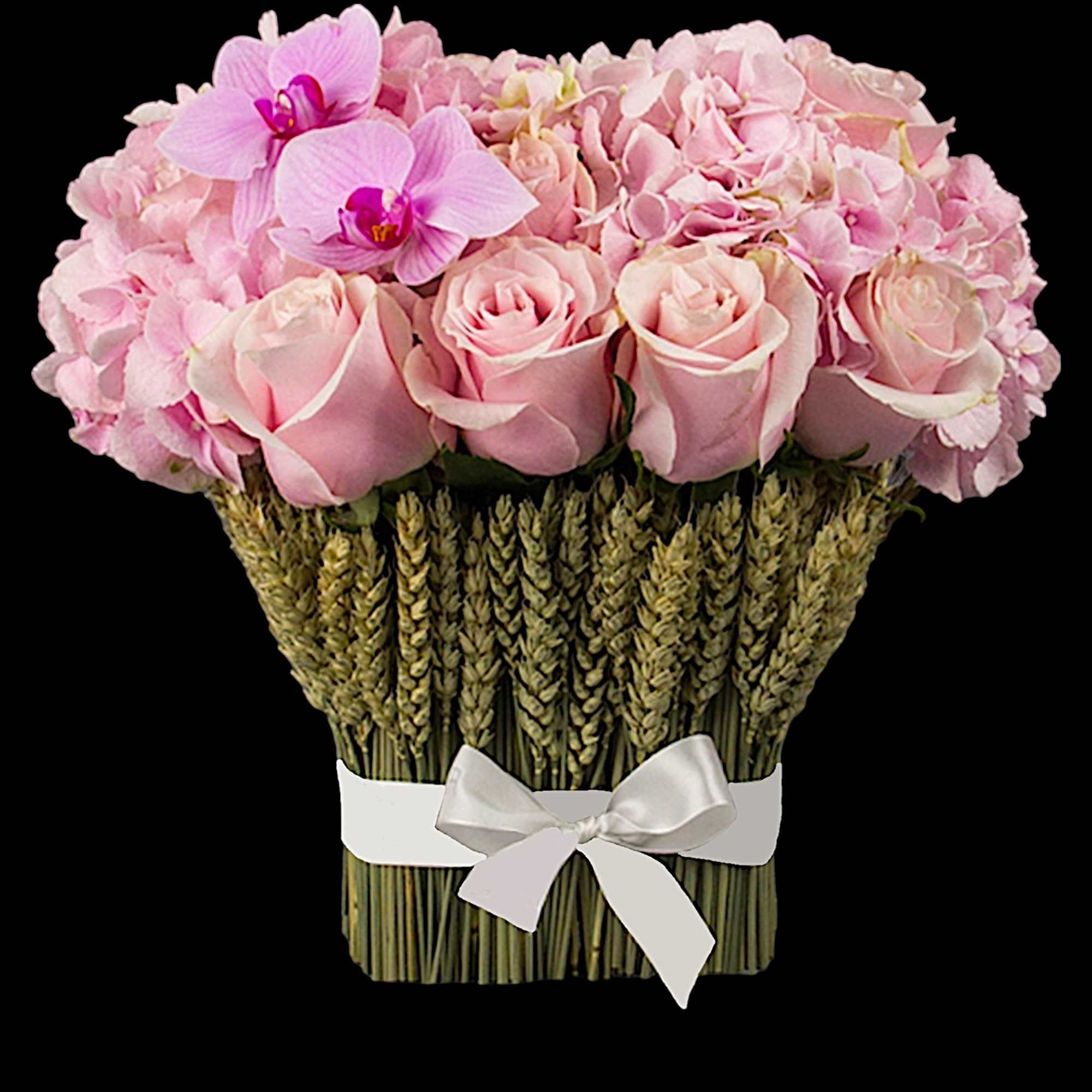 Pink roses and orchids arranged in a woven vase with a white ribbon