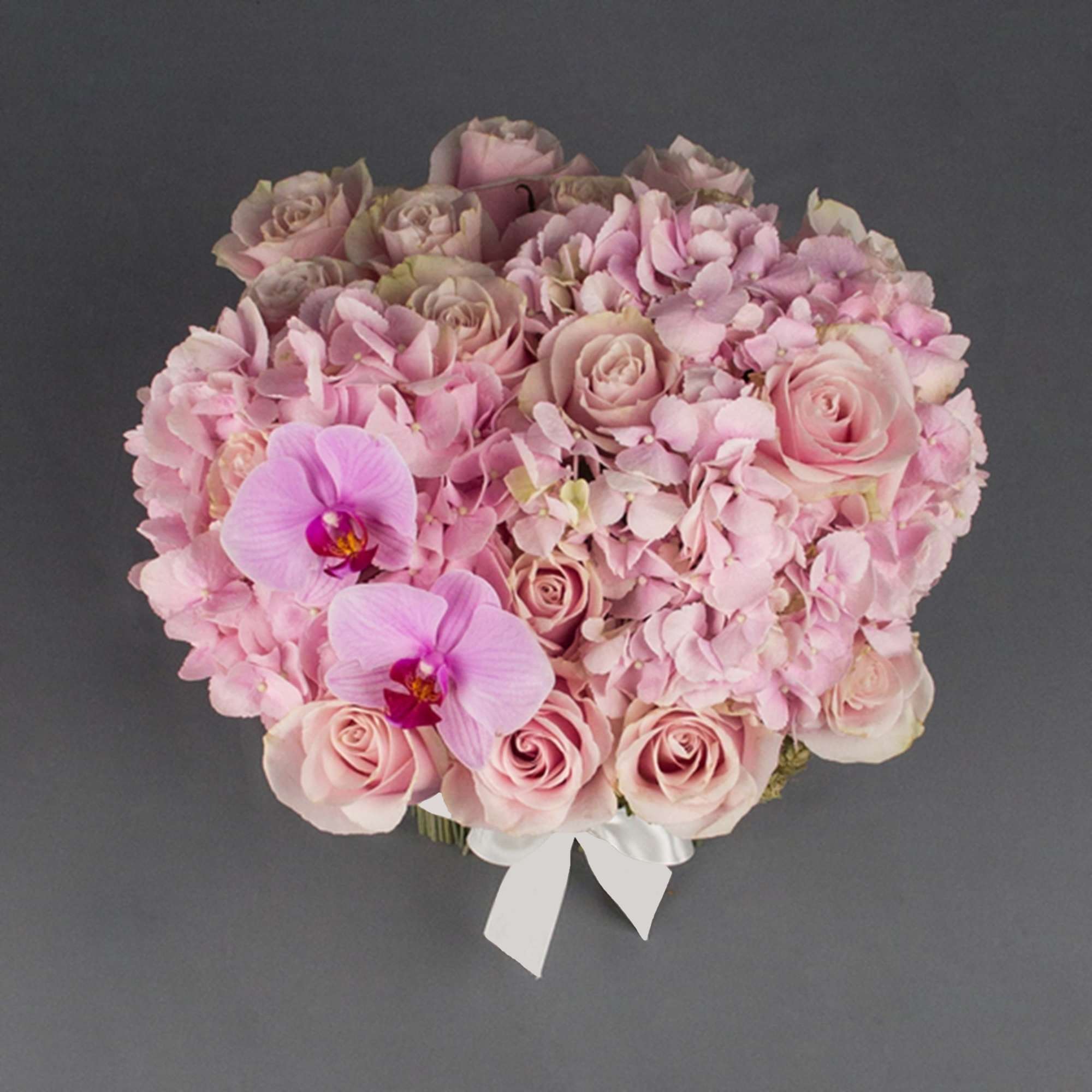 Pink rose and hydrangea bouquet with two orchid blooms