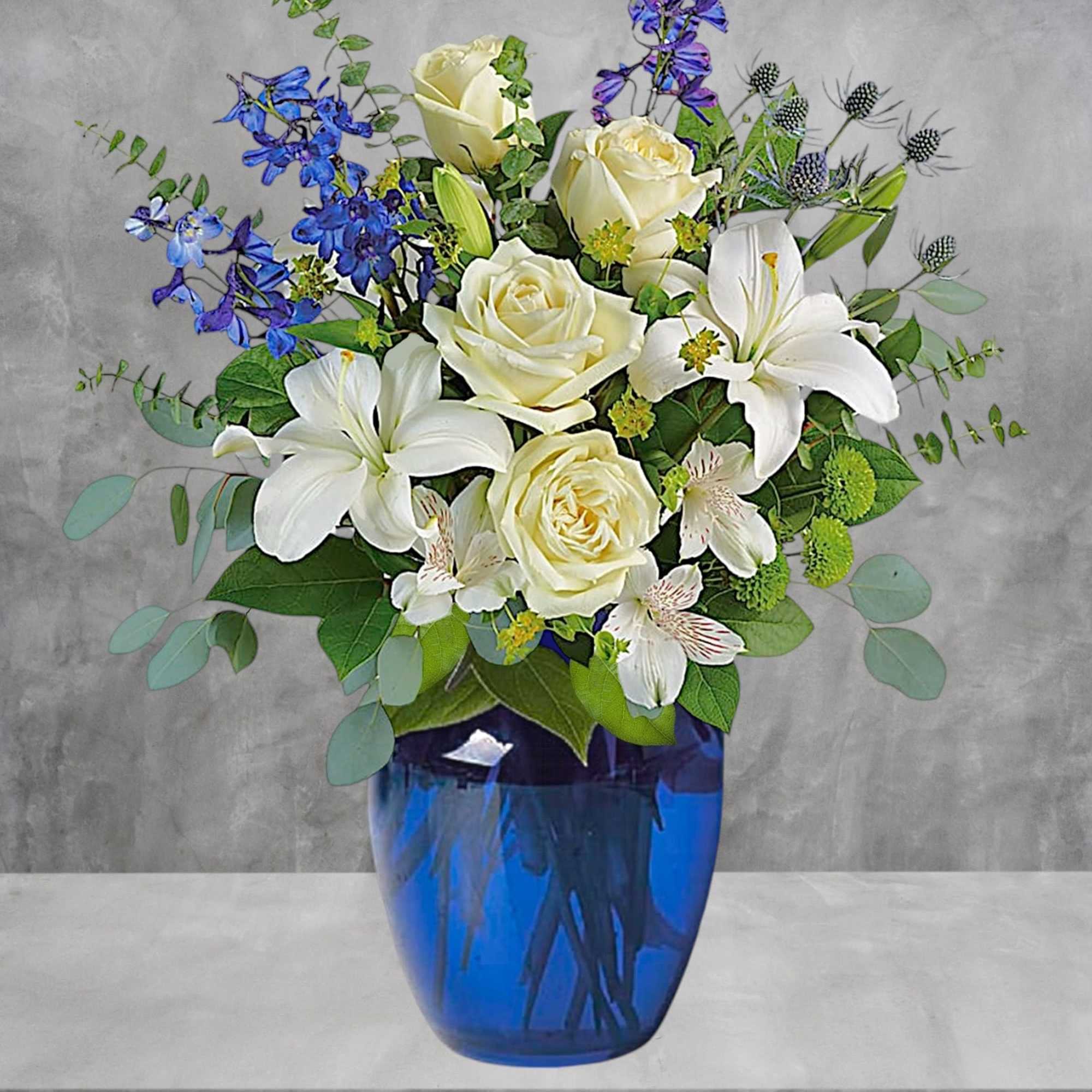 White roses and lilies in a blue glass vase with blue flowers, photo 2 of 4