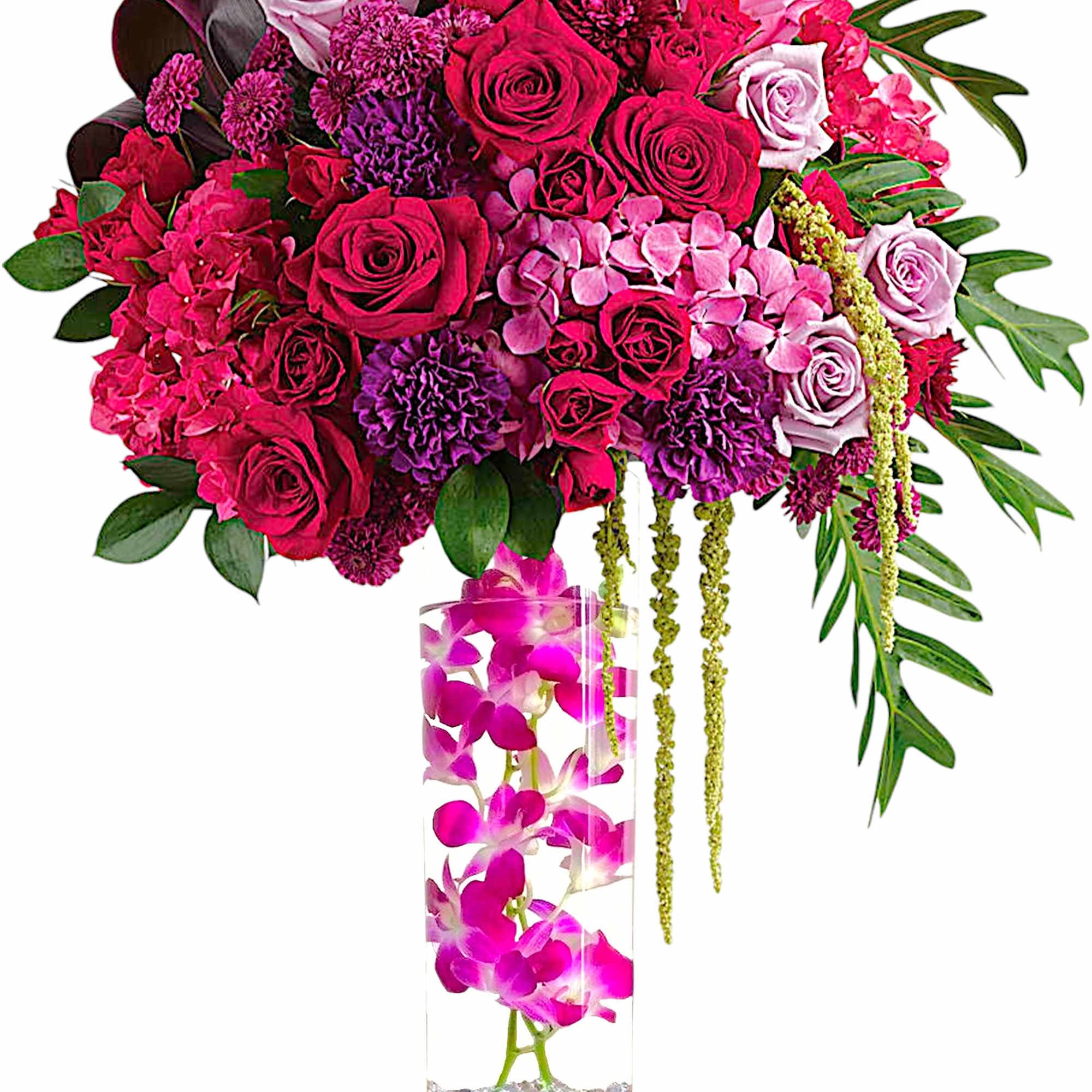Pink and purple rose arrangement in a tall clear vase with orchids