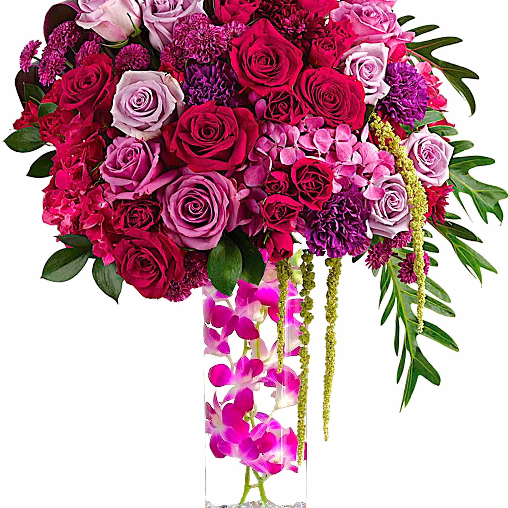 Pink and purple rose arrangement in a tall glass vase with orchids
