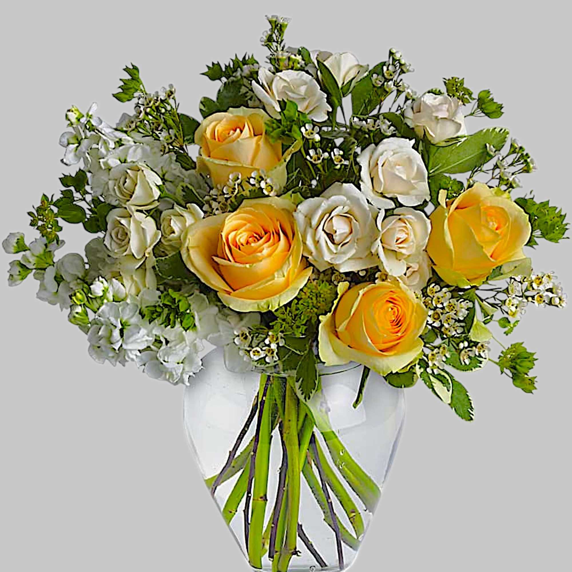 Yellow and white roses arranged in a clear glass vase, photo 4 of 4