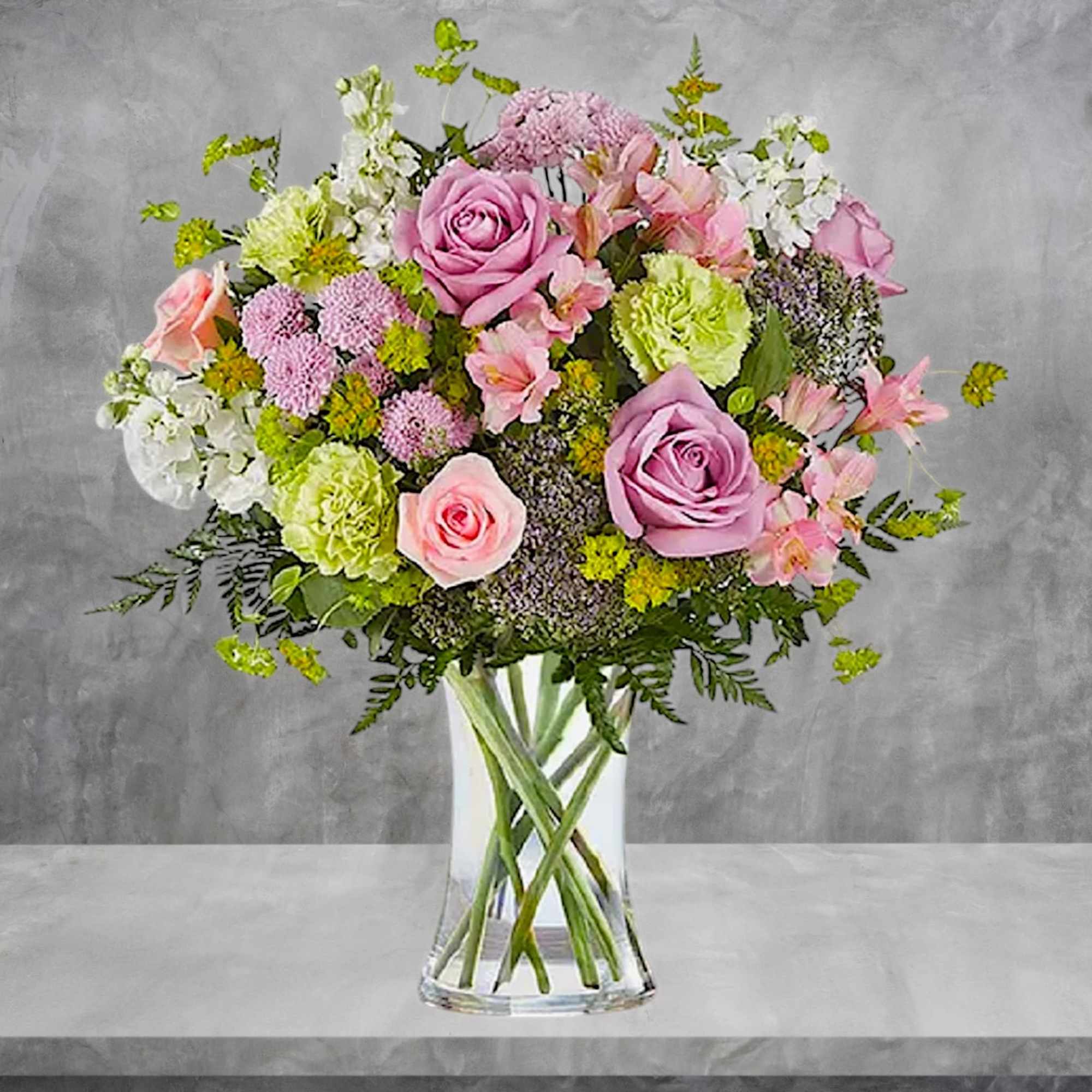 Pink and lavender mixed bouquet in a clear glass vase, photo 3 of 6
