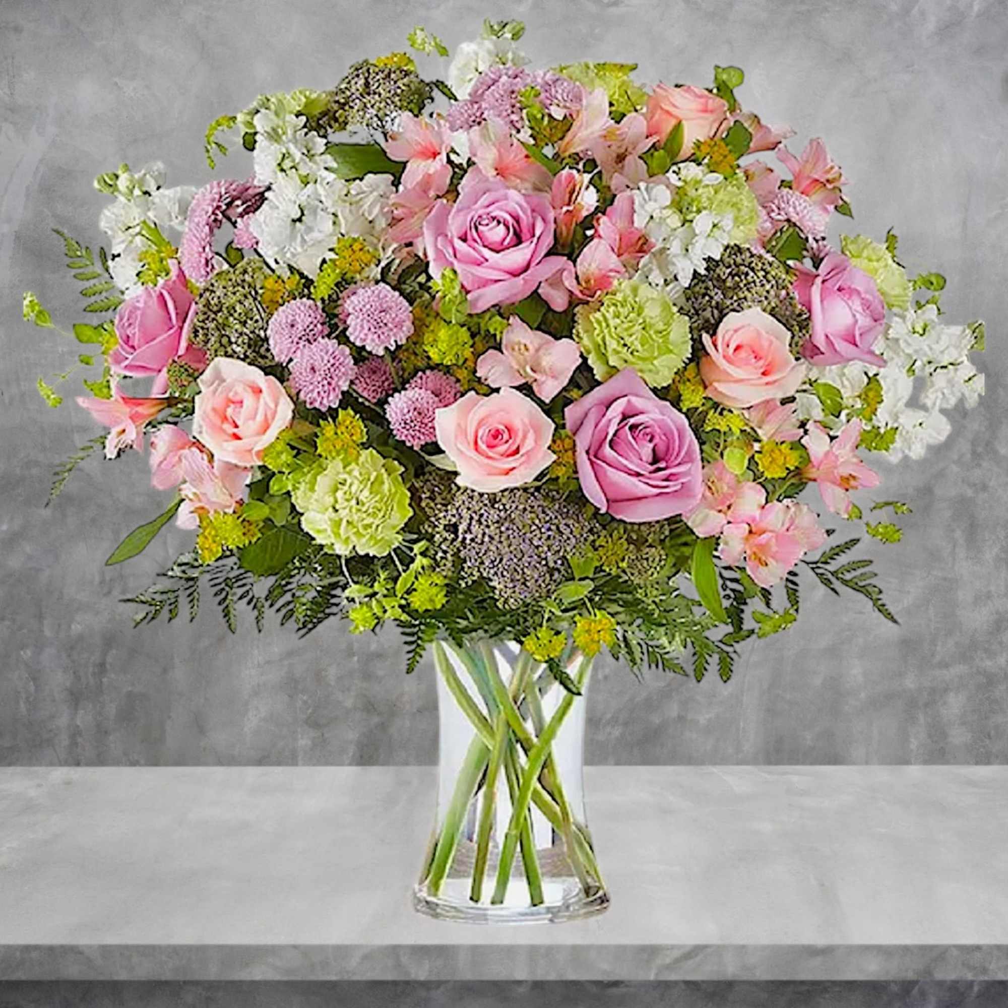 Mixed pink and white flower bouquet in a clear glass vase, photo 3 of 6