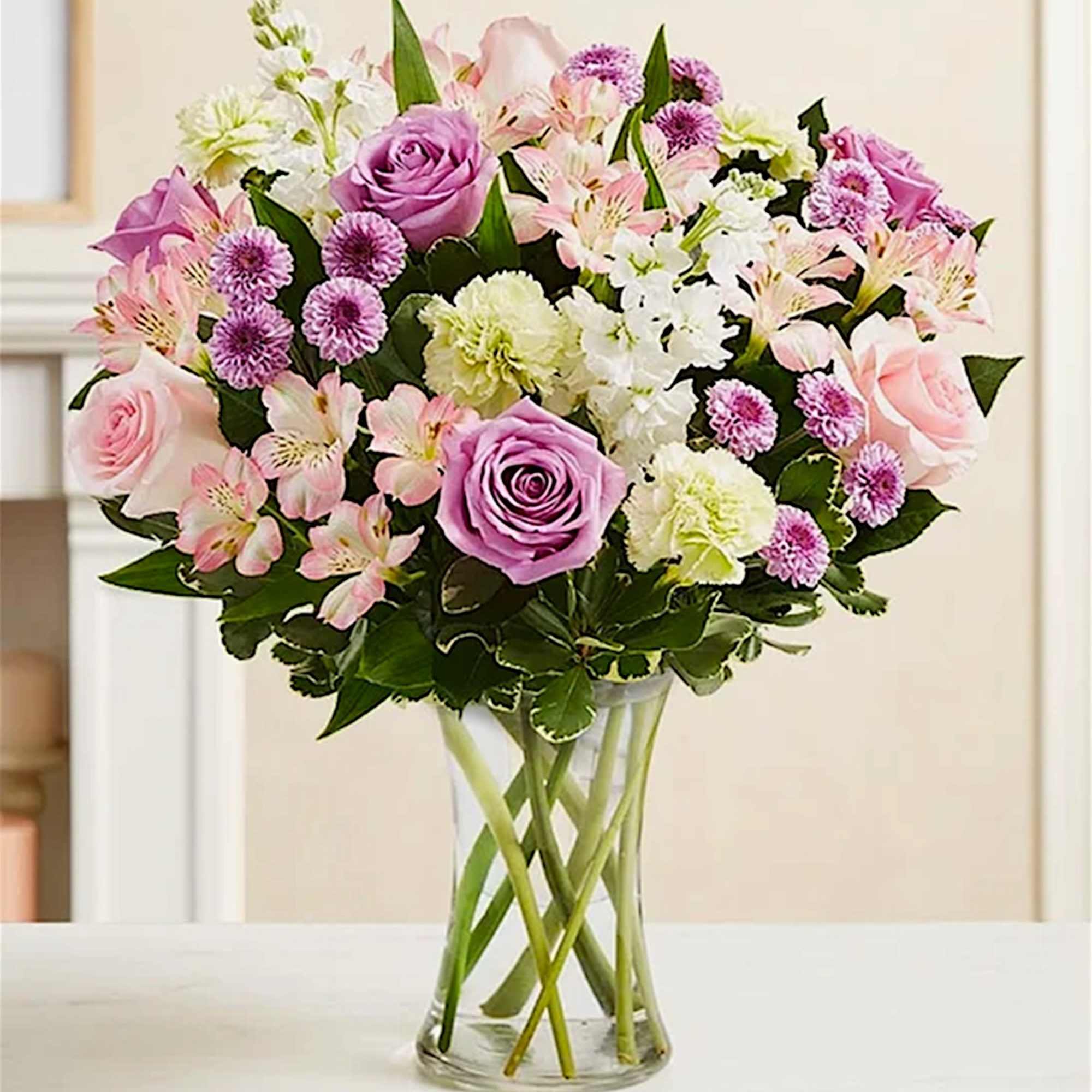 Pink and lavender mixed bouquet in a clear glass vase