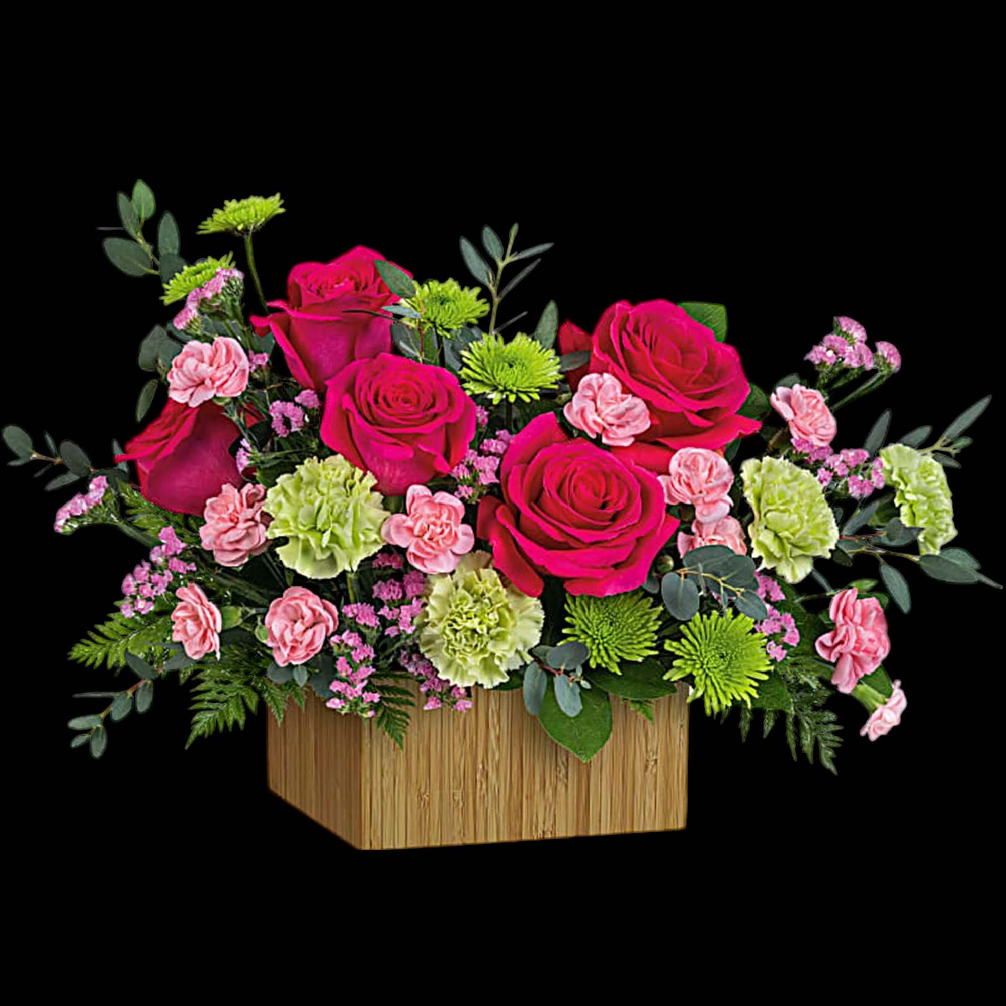 Pink roses and carnations in a wooden box