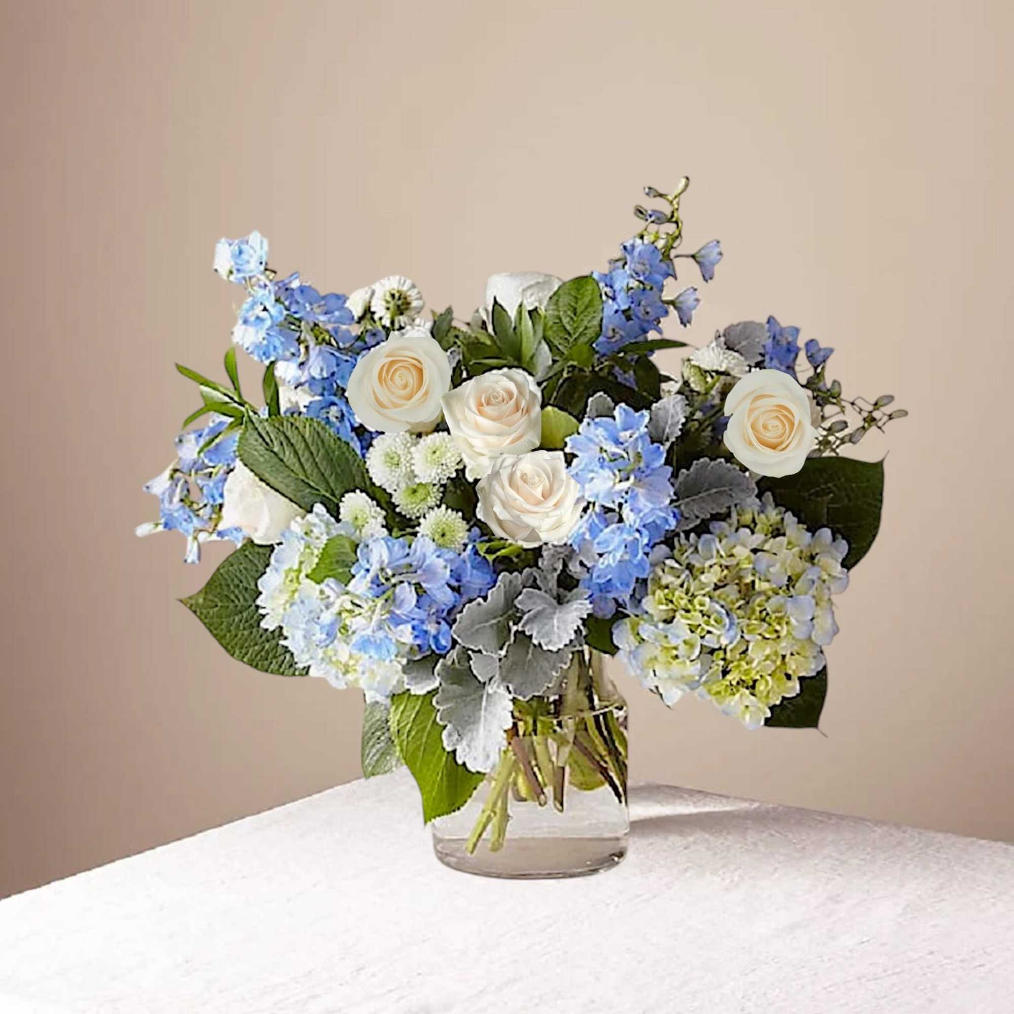 Blue and white flower arrangement in a clear glass vase, photo 3 of 7