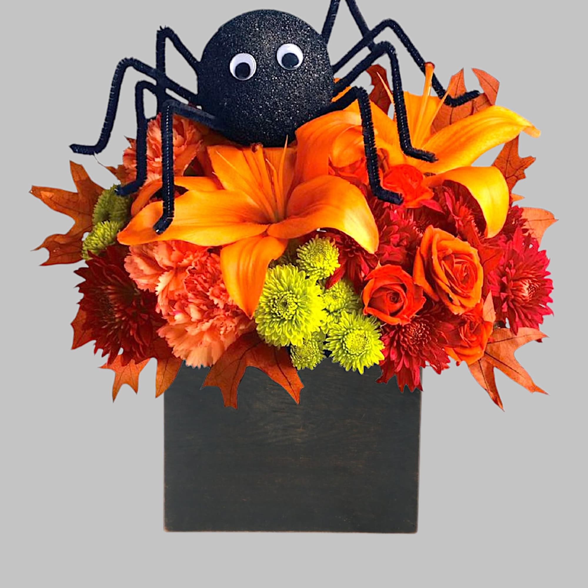 Halloween floral arrangement with a black spider decoration in a black box