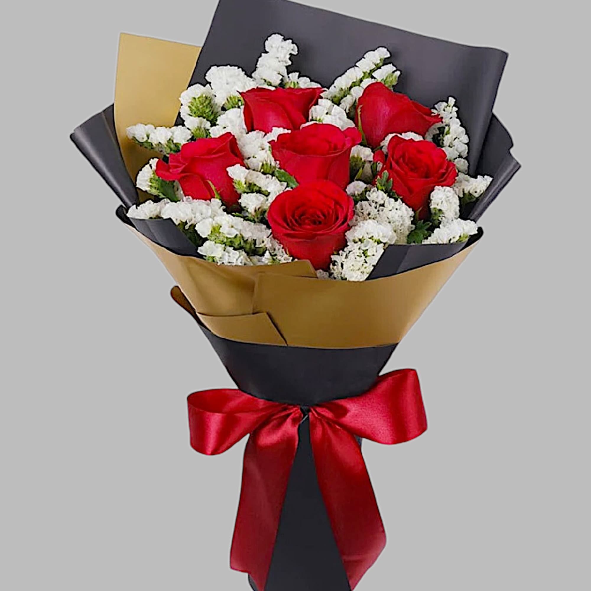 Bouquet of red roses with white filler flowers wrapped in black and gold paper, photo 4 of 5