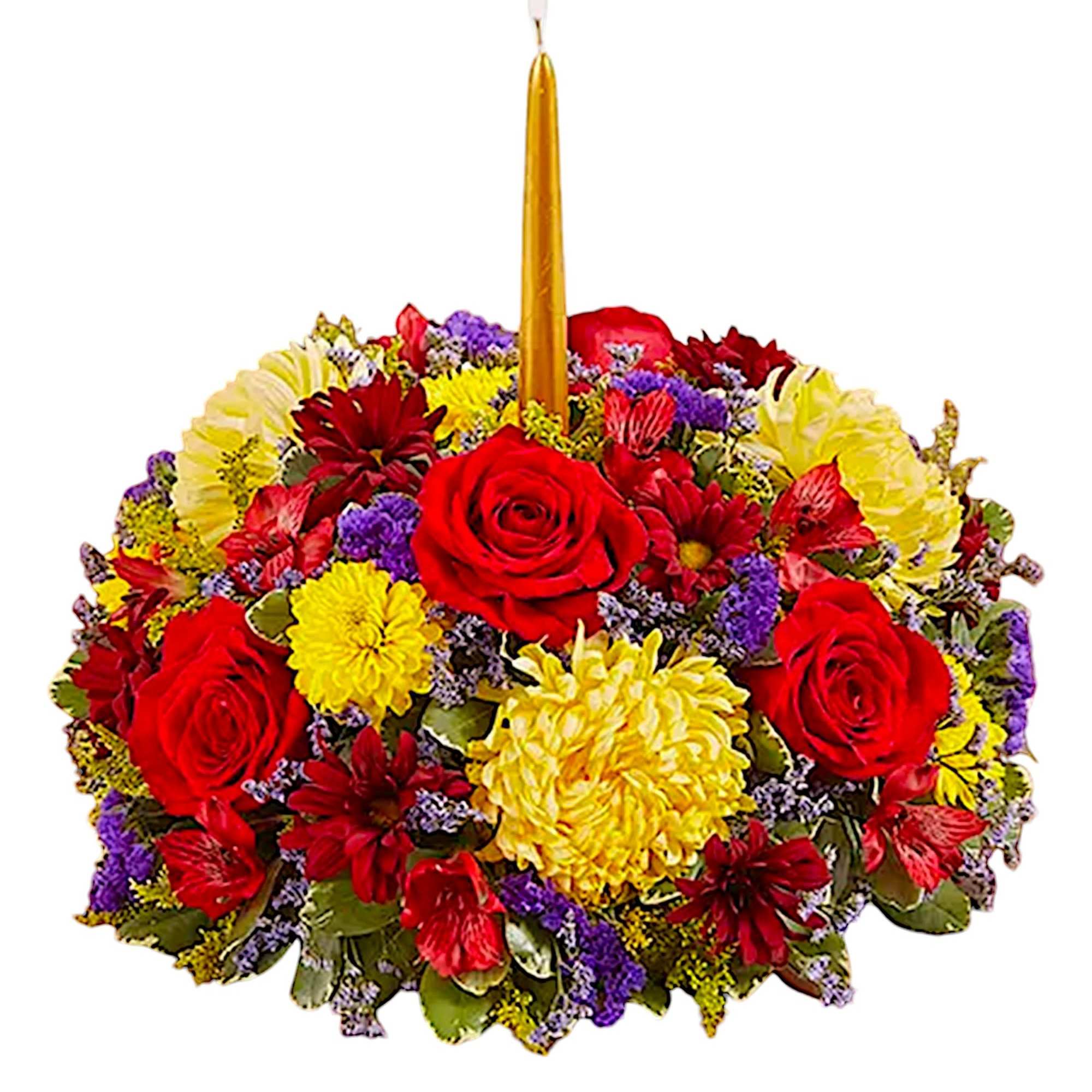 Round floral arrangement with a tall gold candle in the center