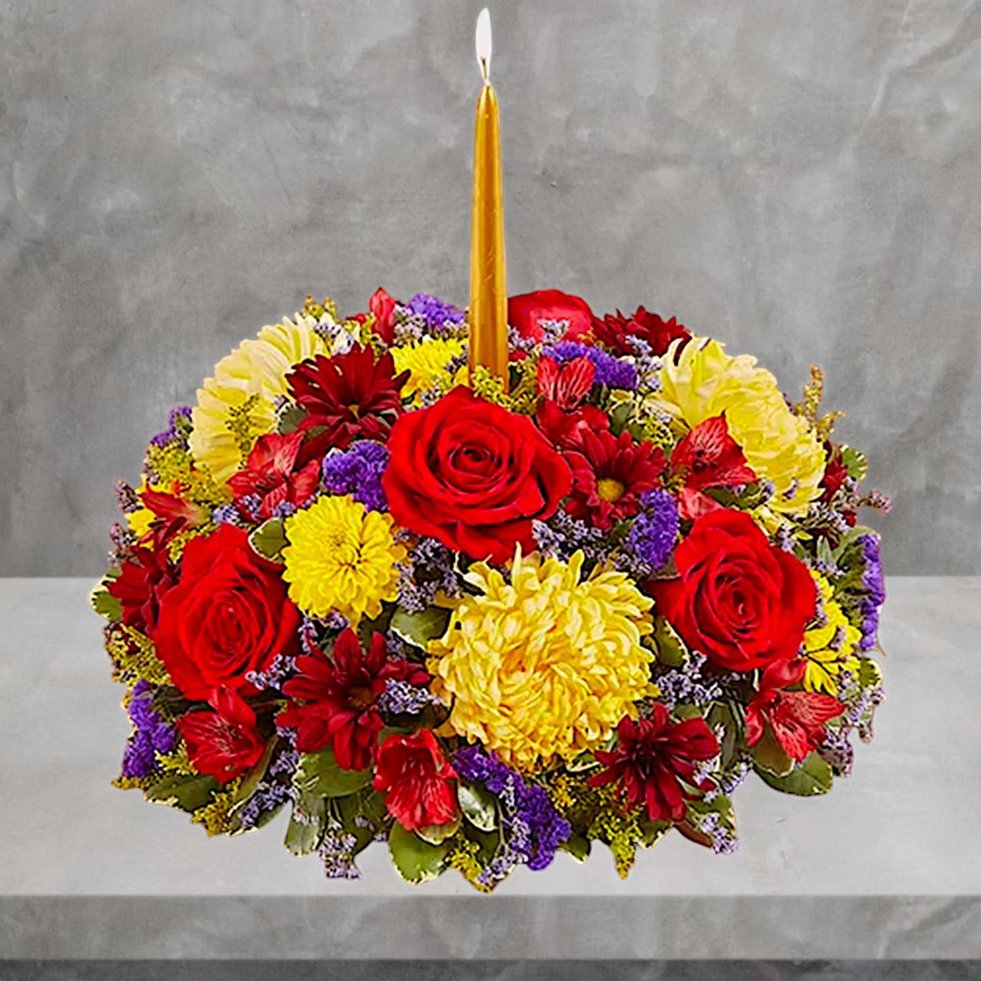 Round floral centerpiece with a tall gold candle in the middle, photo 4 of 7