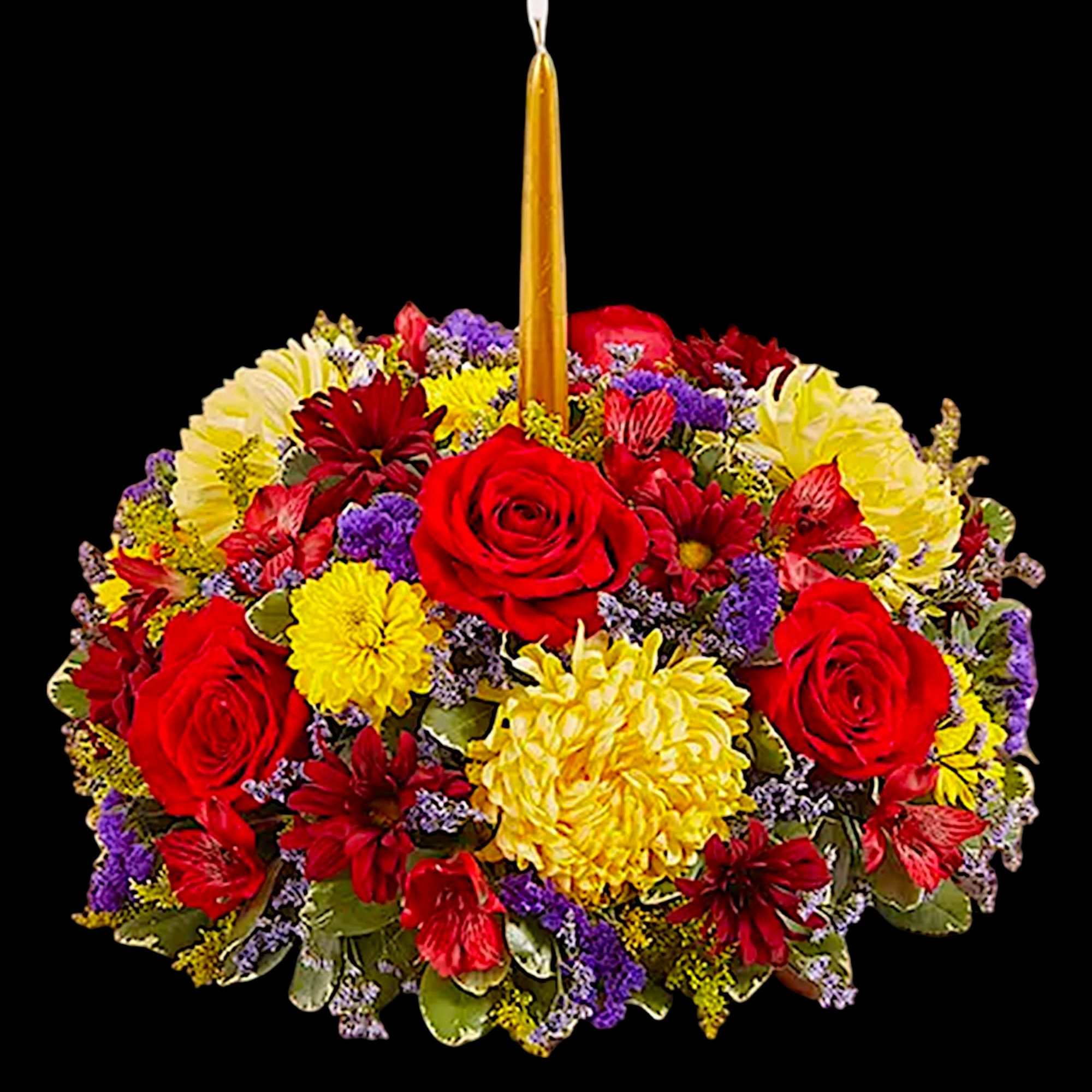 Round floral arrangement with a tall candle in the center