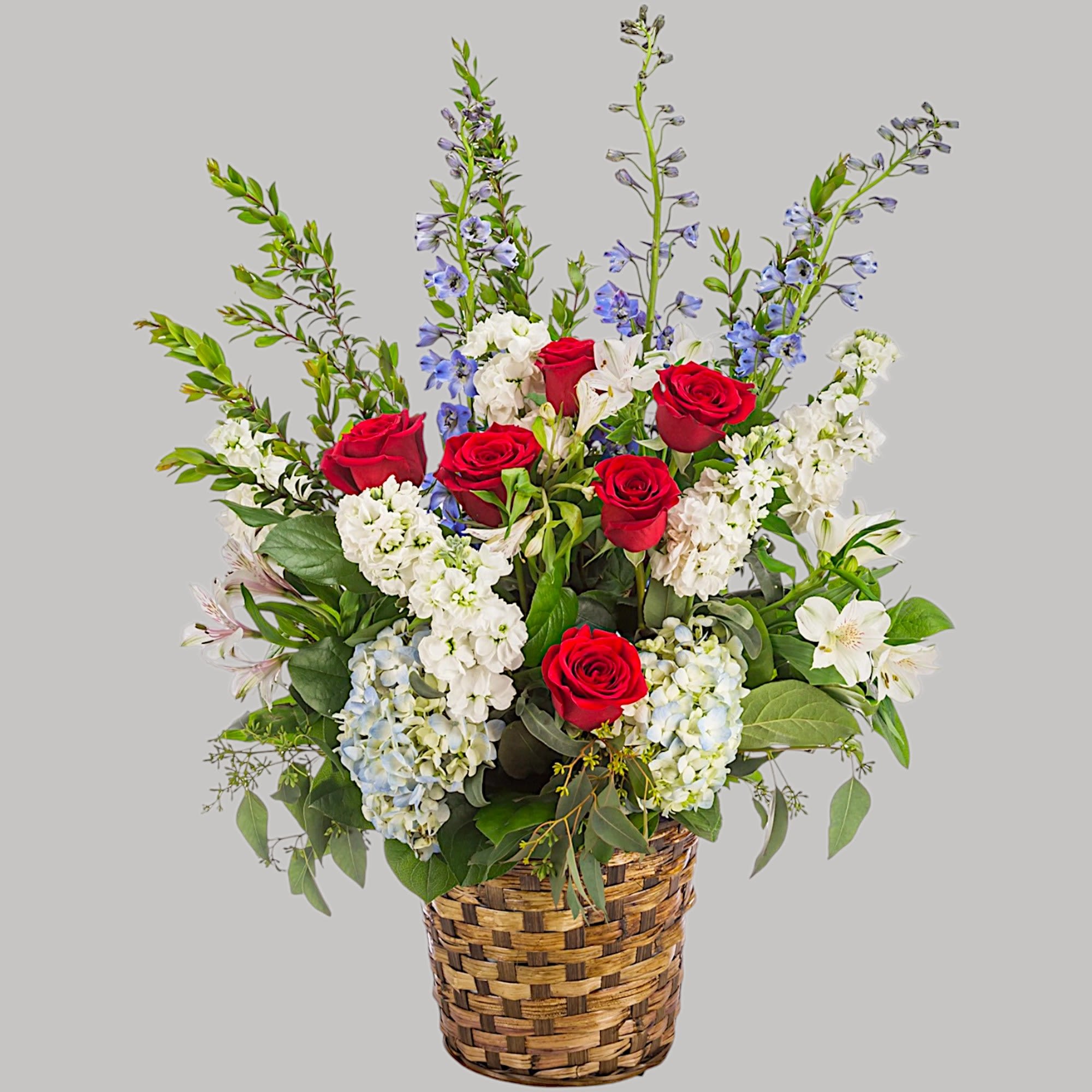 A red, white, and blue tribute flower basket featuring red roses, blue, photo 5 of 5