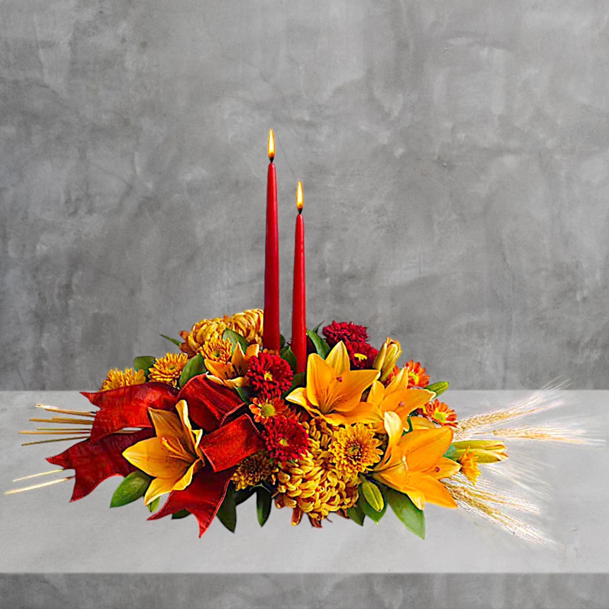 Autumn floral centerpiece with two red taper candles