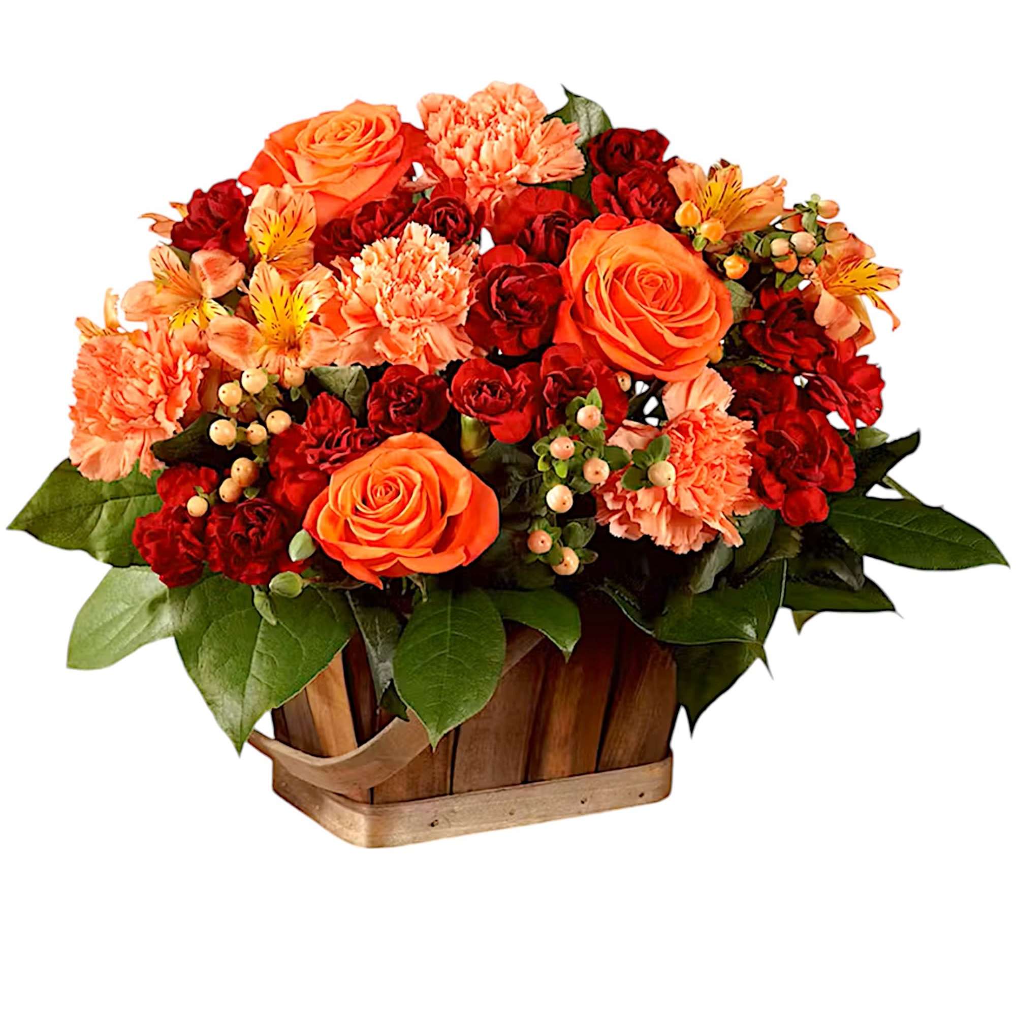 Orange and red flower arrangement in a wooden basket