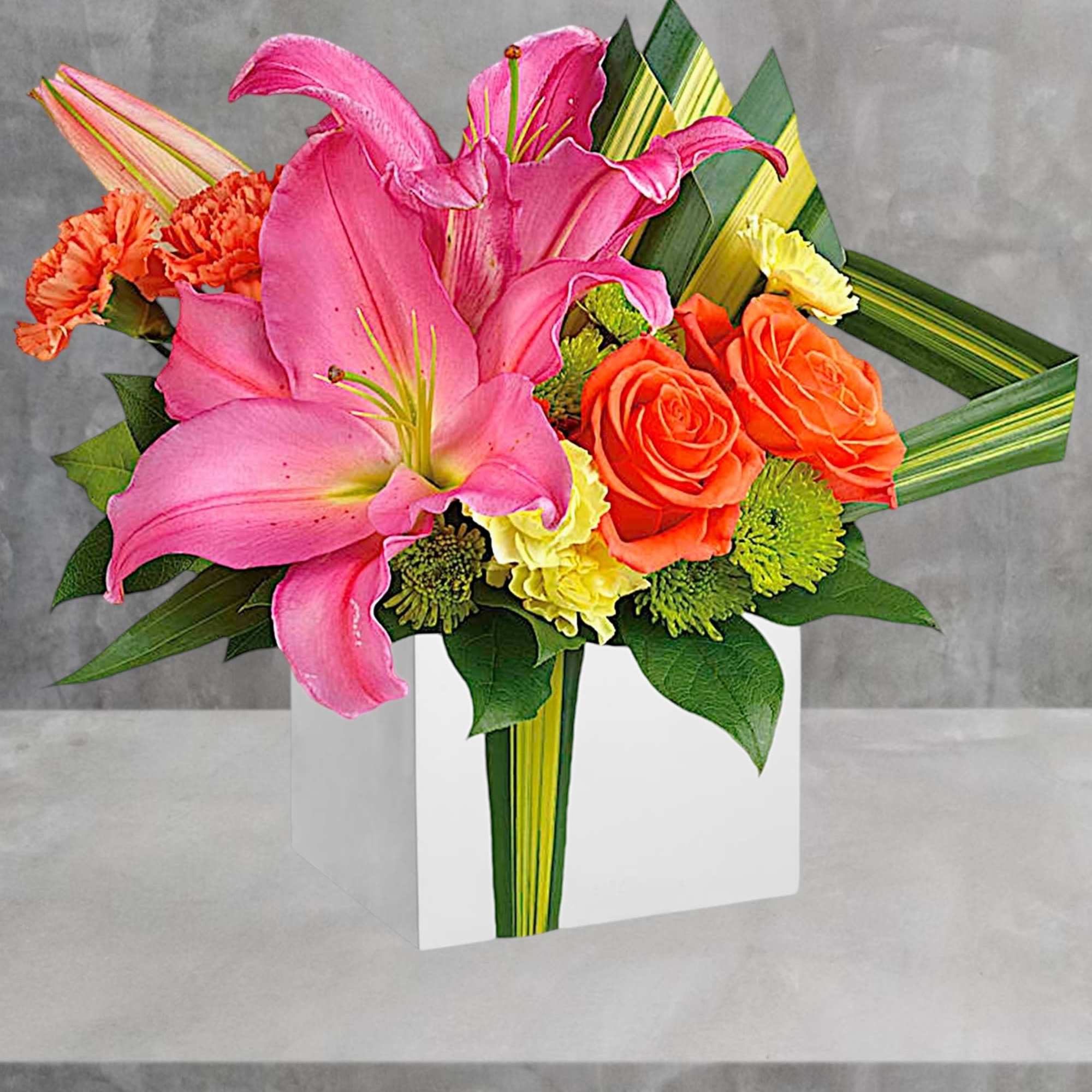 Pink lilies and orange roses arranged in a white vase