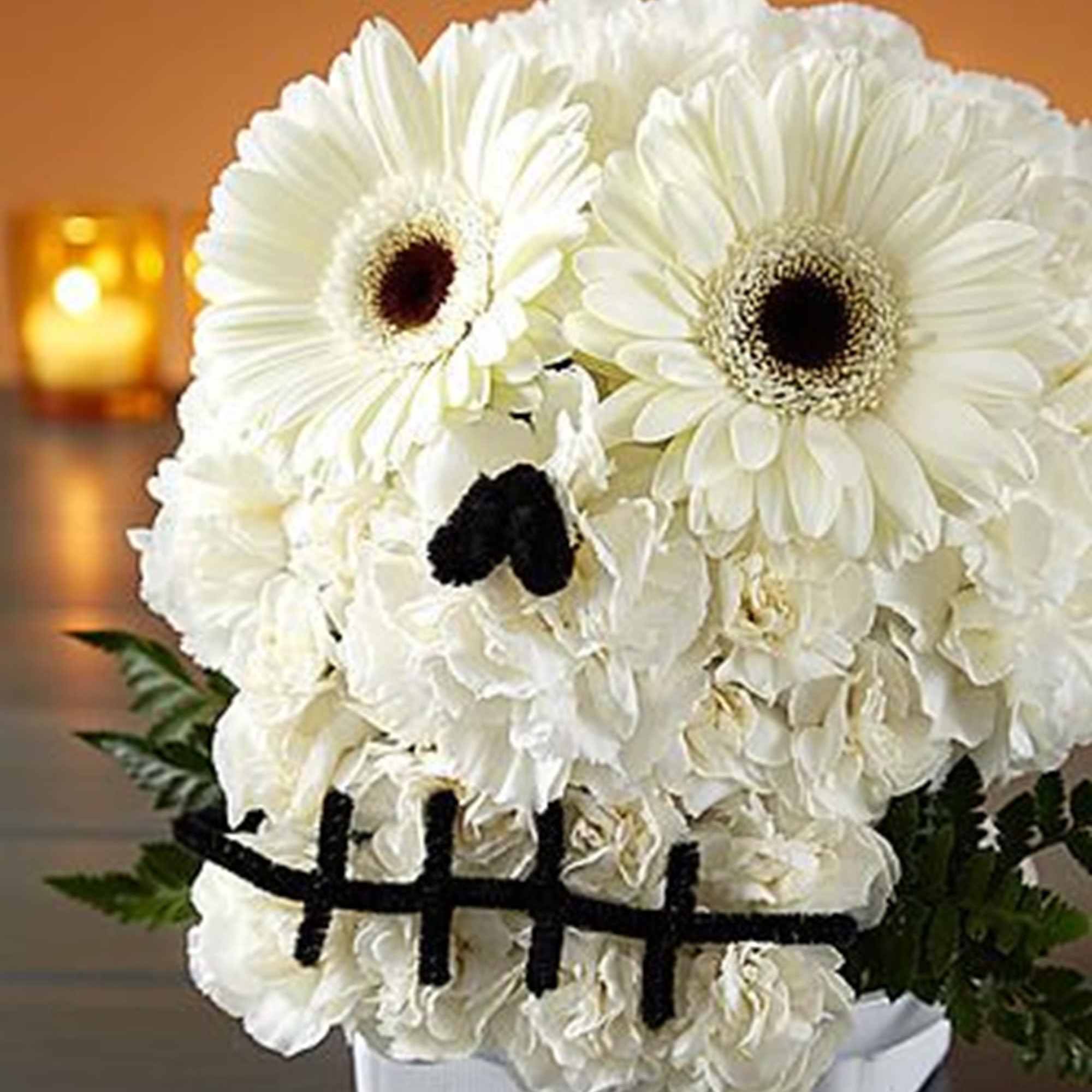 White floral arrangement shaped like a skull with black accents