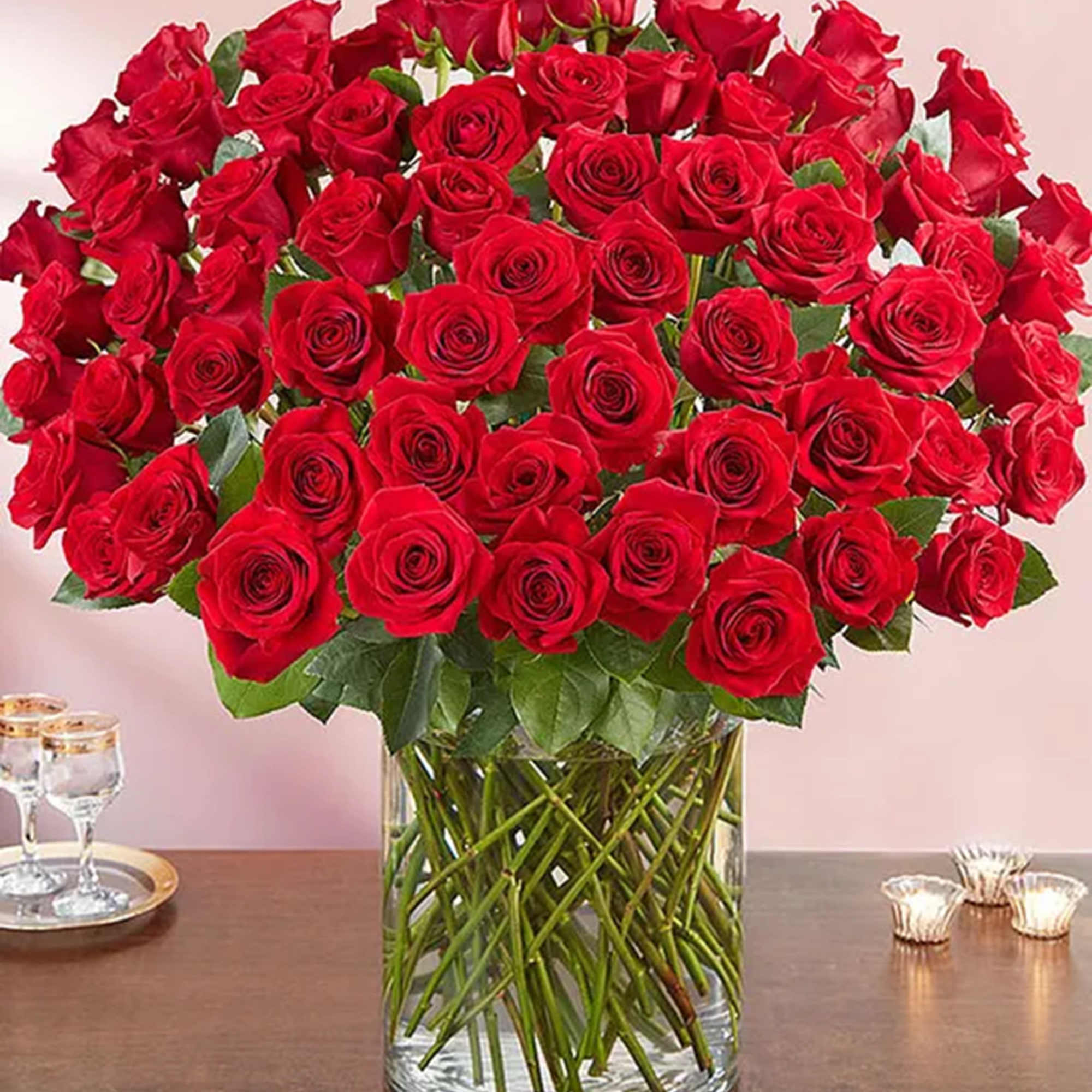 Large bouquet of red roses in a clear glass vase