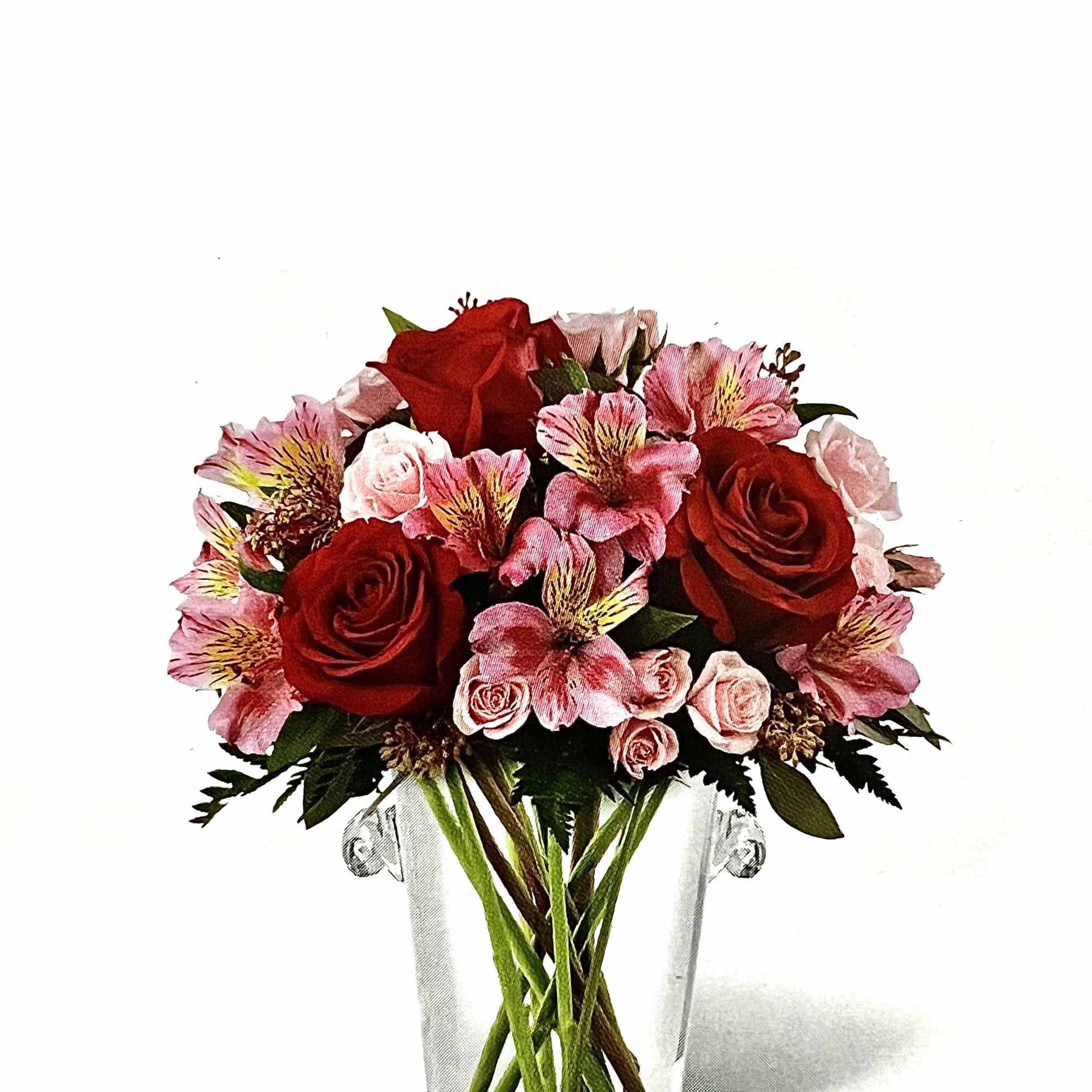 Red and pink flower bouquet in a clear glass vase