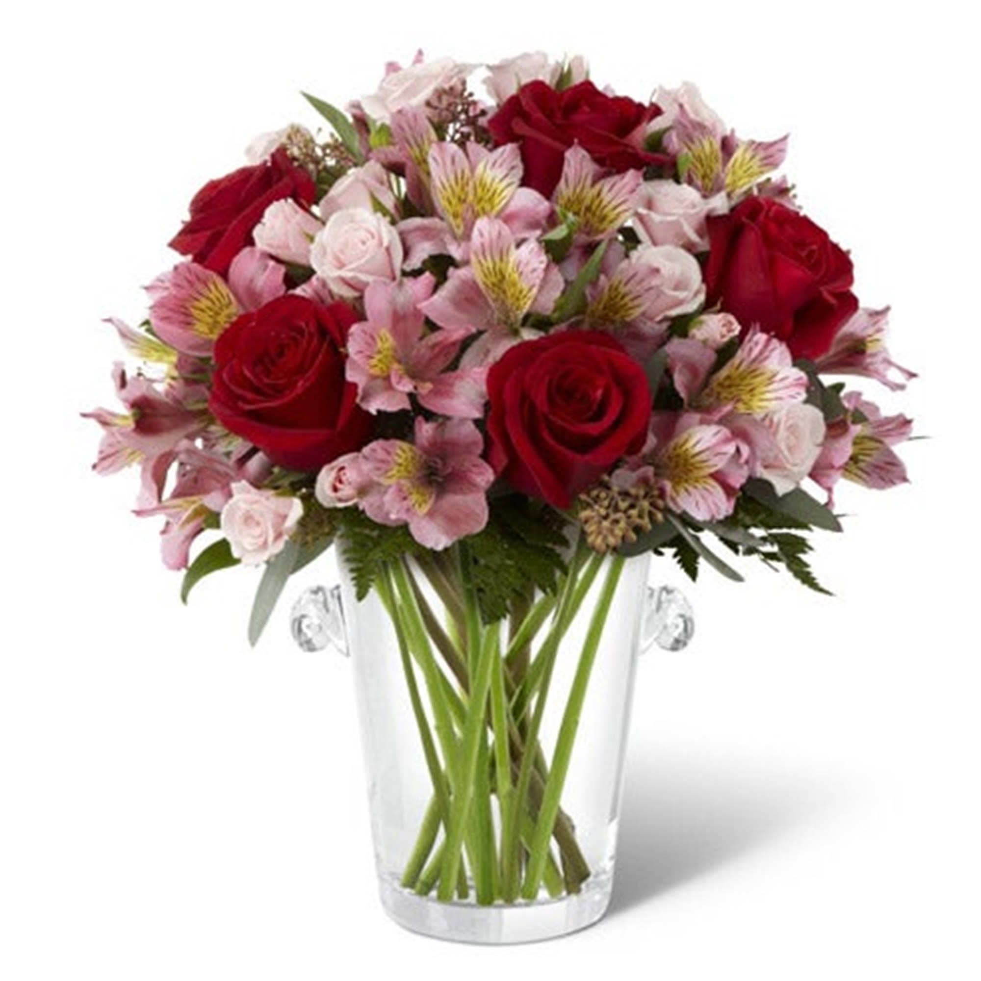 Bouquet of red roses and pink alstroemeria in a clear glass vase