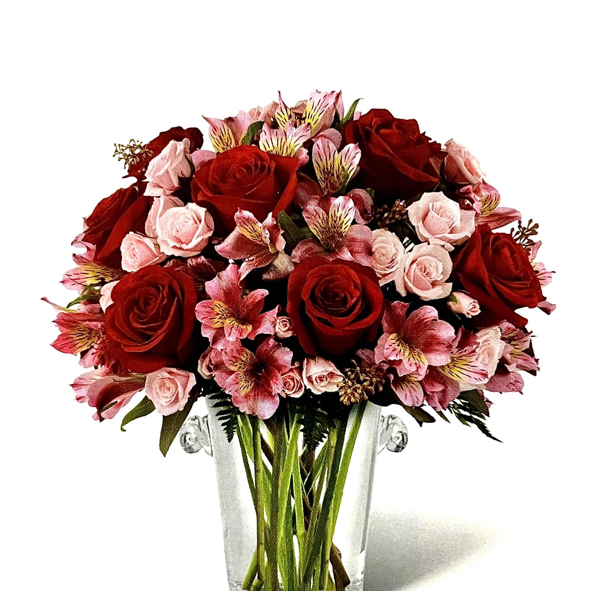 Bouquet of red and pink roses in a clear glass vase