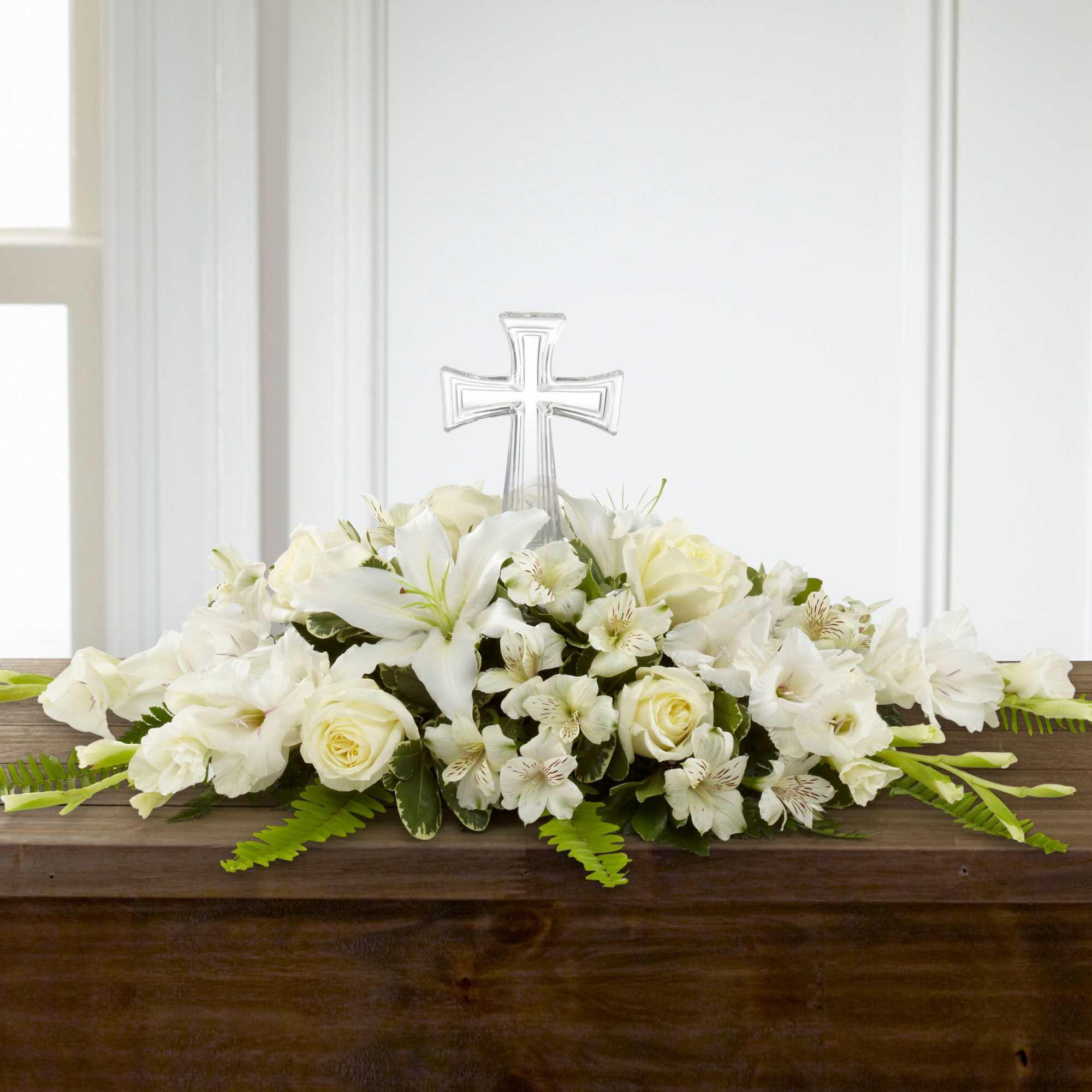 White floral casket spray with a clear cross centerpiece, photo 2 of 2