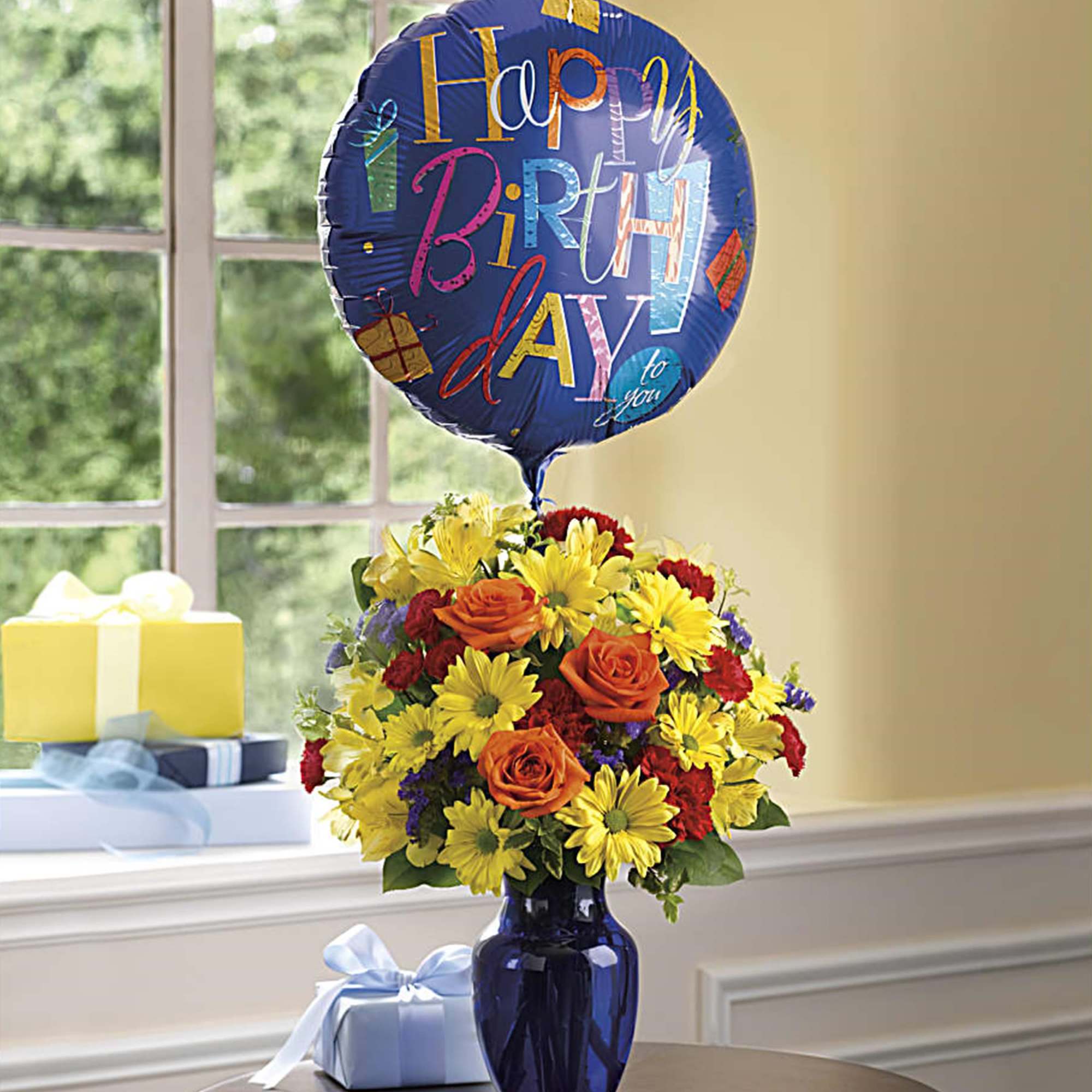 Birthday balloon above a colorful flower arrangement in a blue vase, photo 2 of 2