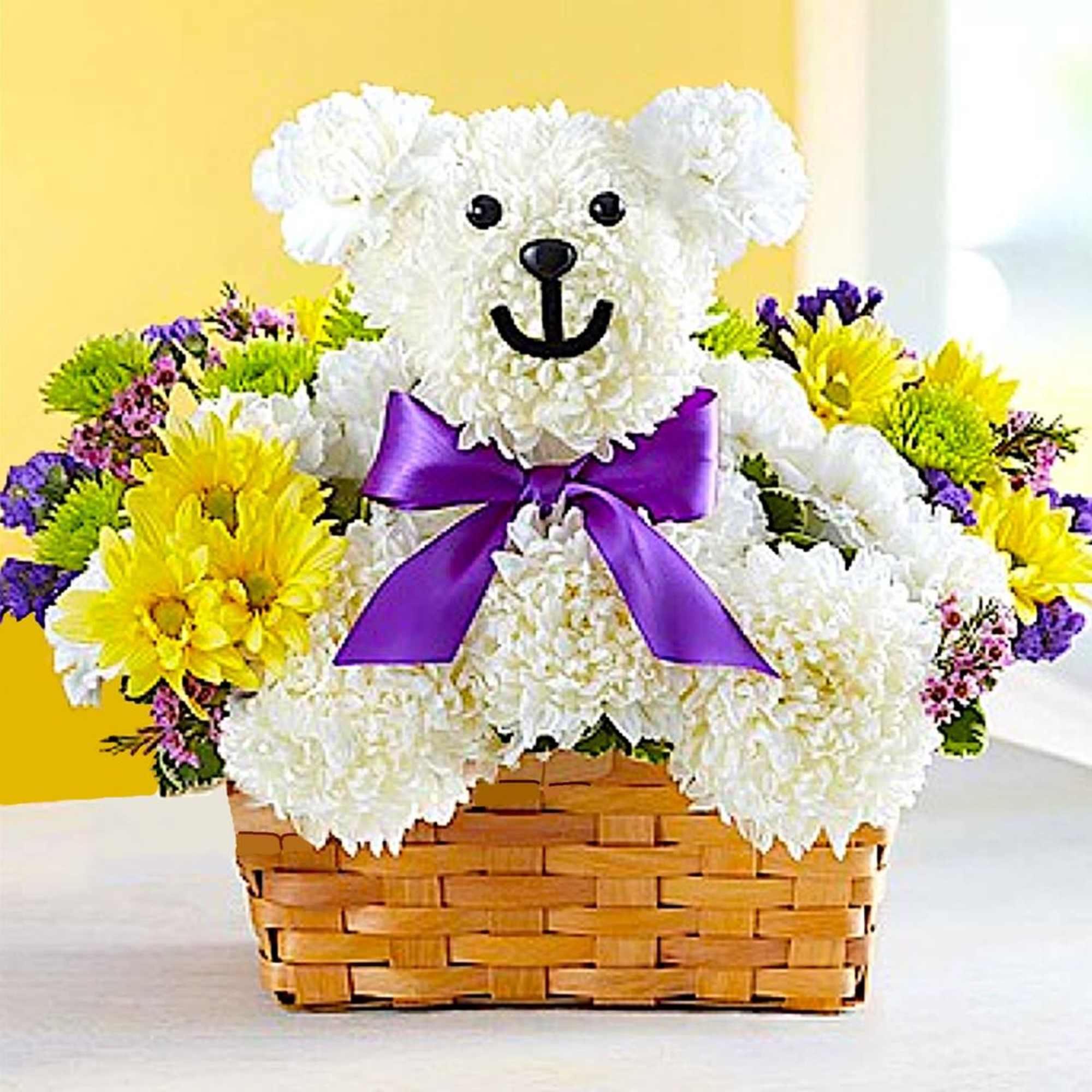 White teddy bear made of flowers in a basket with a purple bow