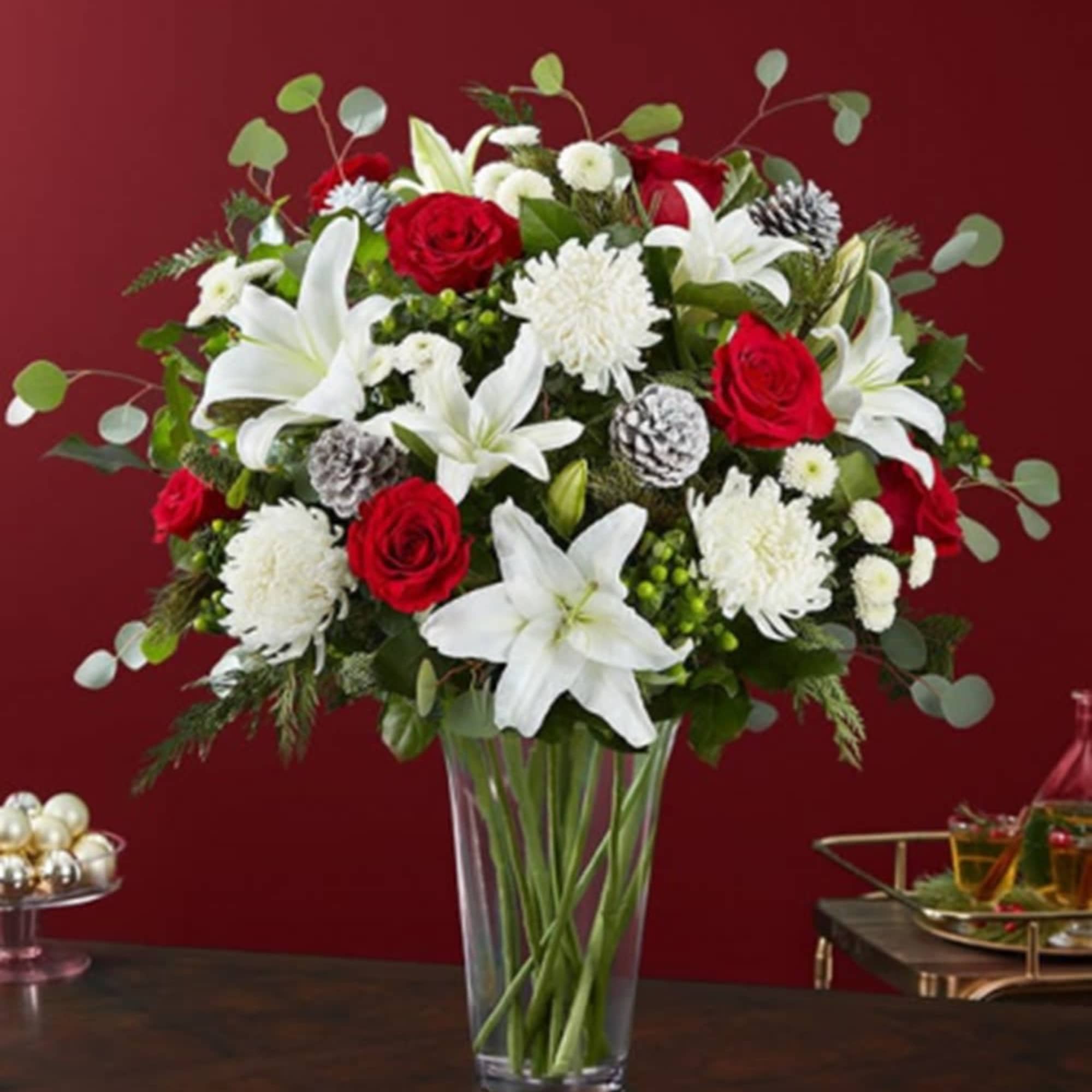 Red roses and white lilies in a clear glass vase