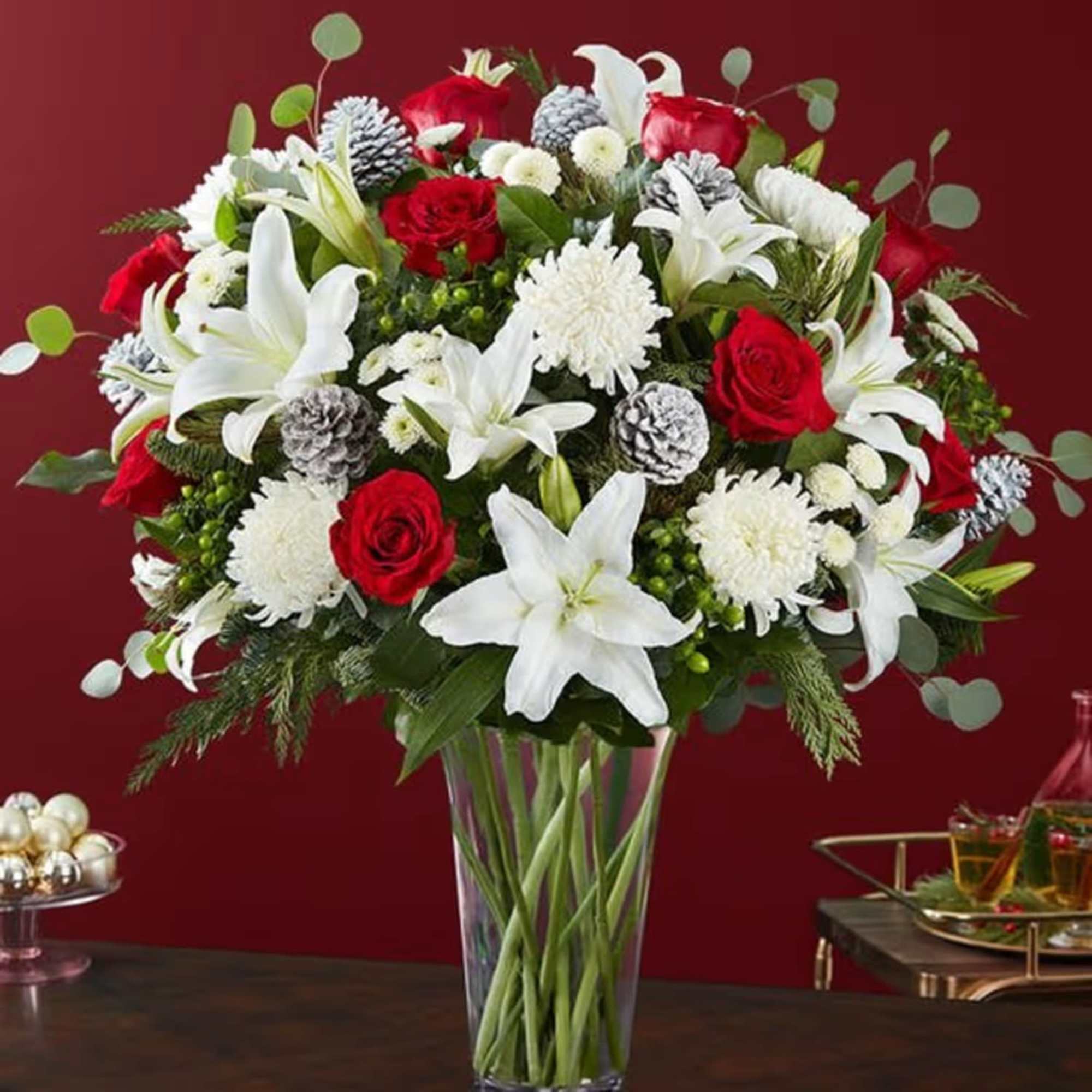 Red roses and white lilies in a clear glass vase