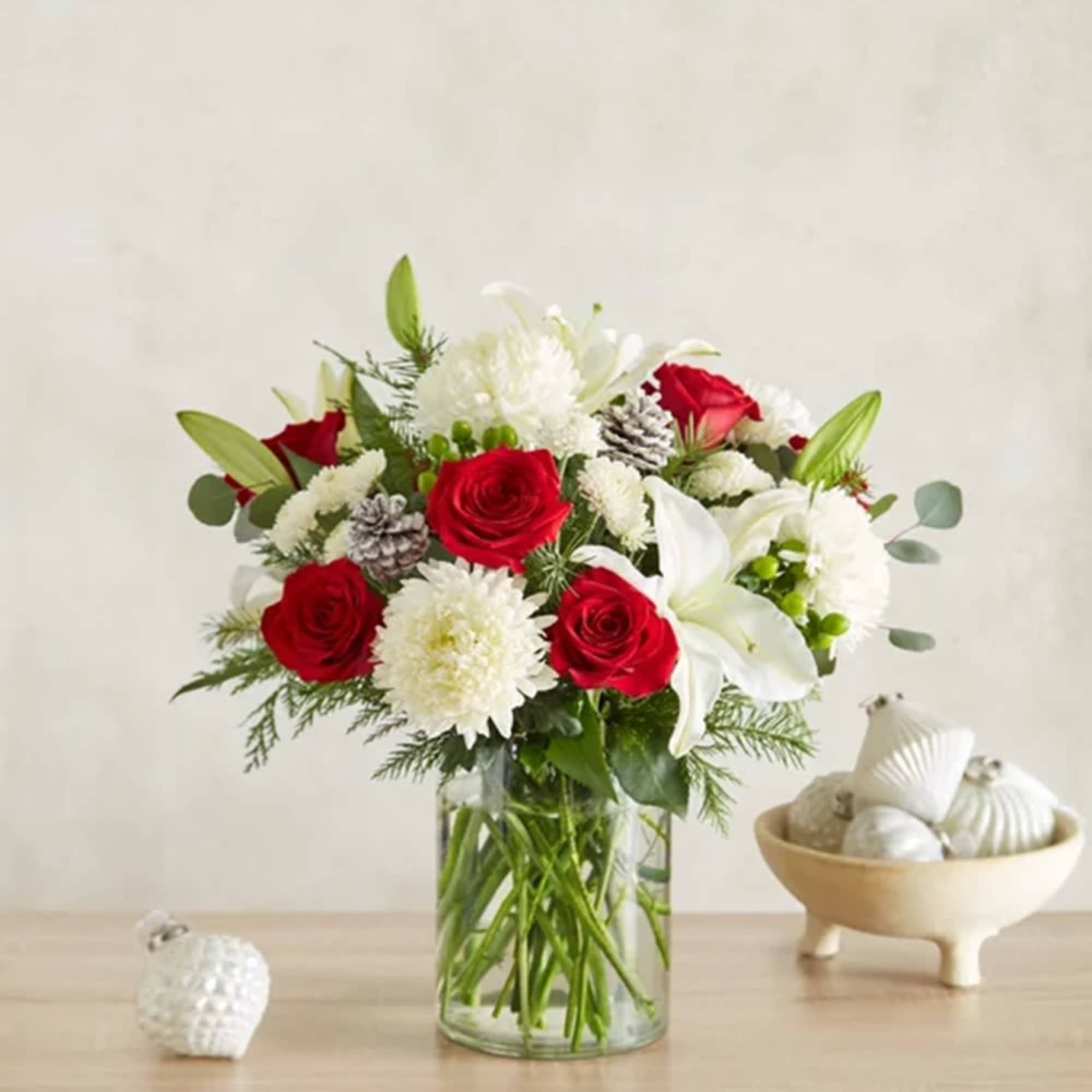 Red roses and white lilies in a clear glass vase