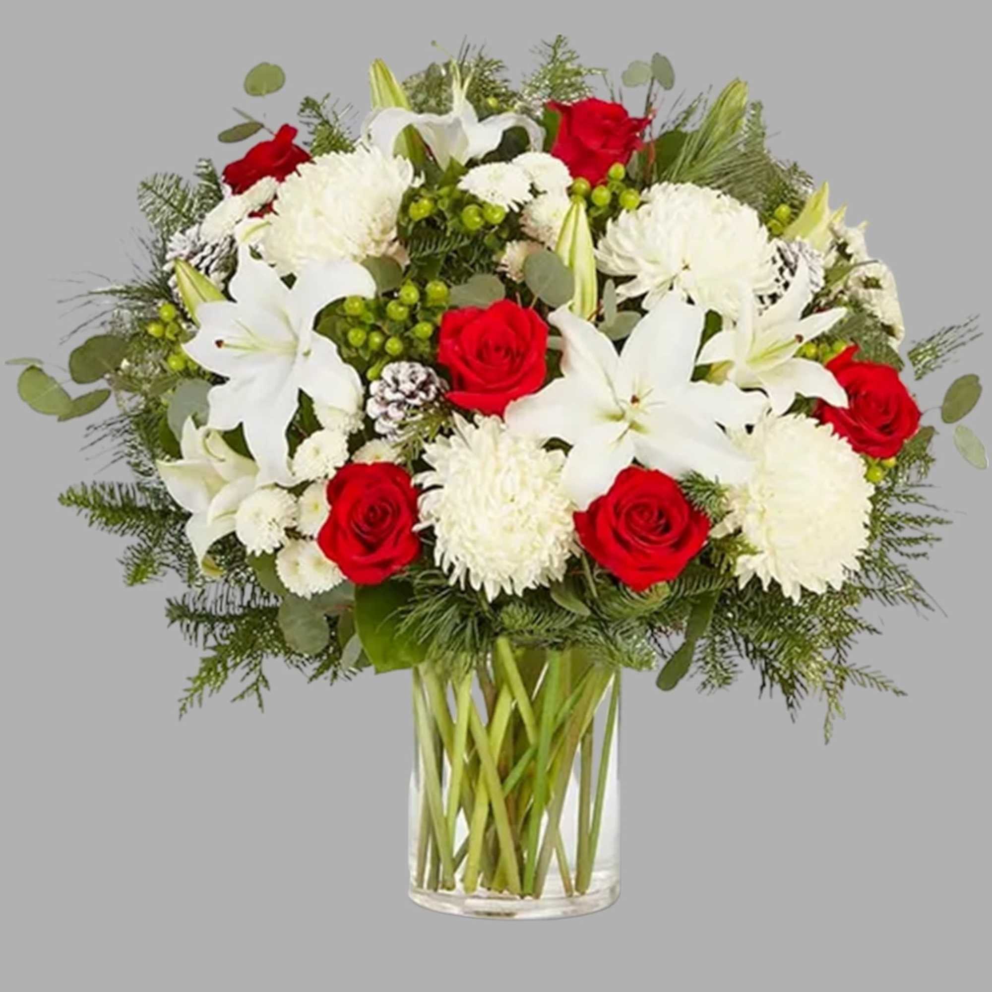 Red roses and white lilies in a clear glass vase
