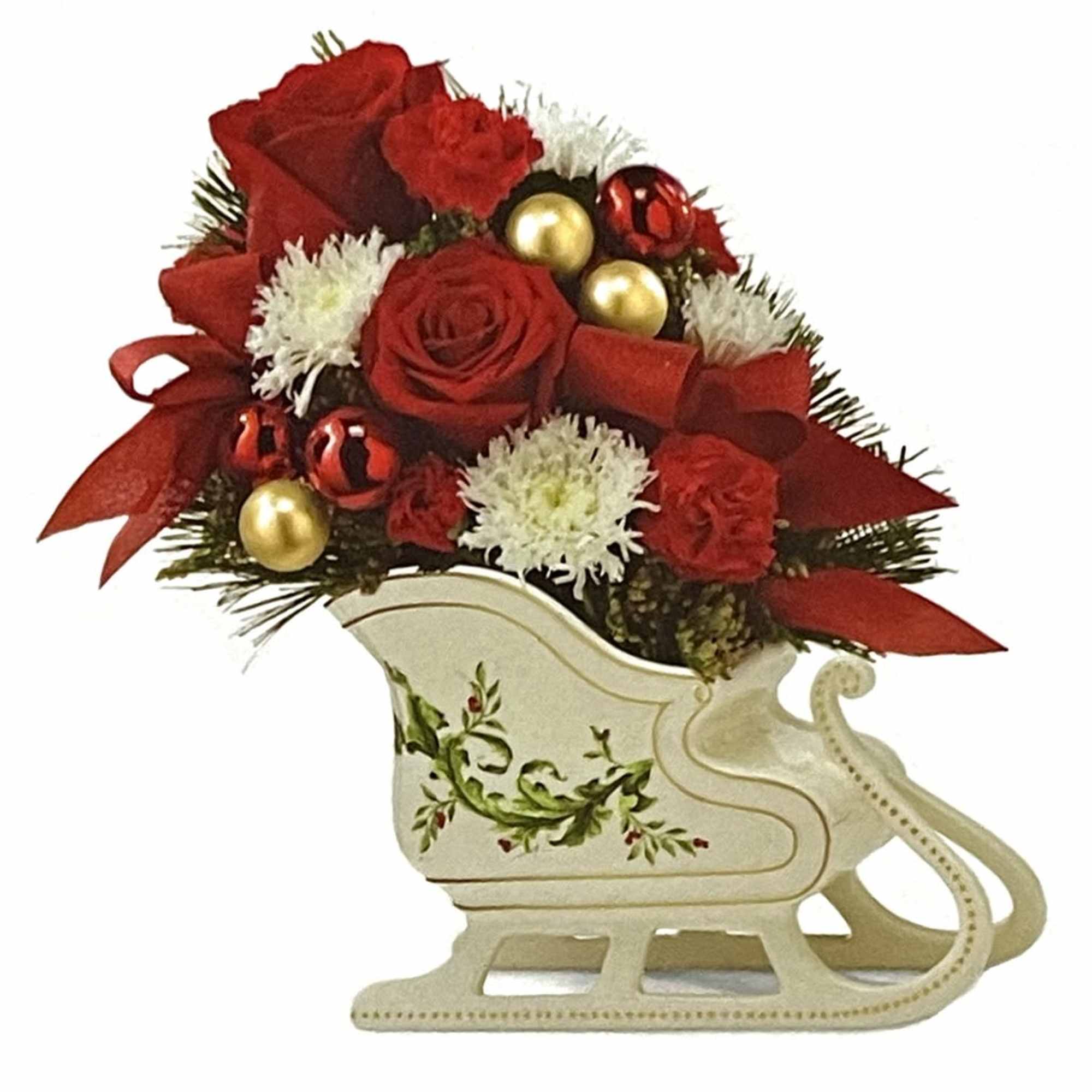 Red roses and white flowers arranged in a decorative sleigh