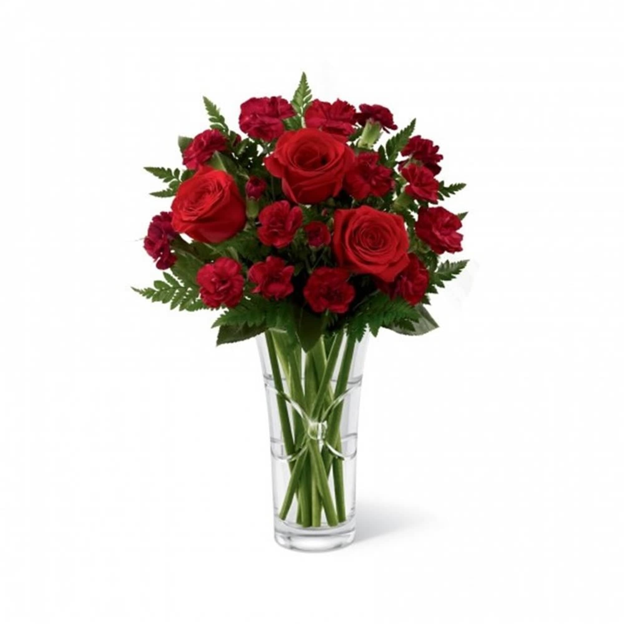 Red roses and carnations in a clear glass vase