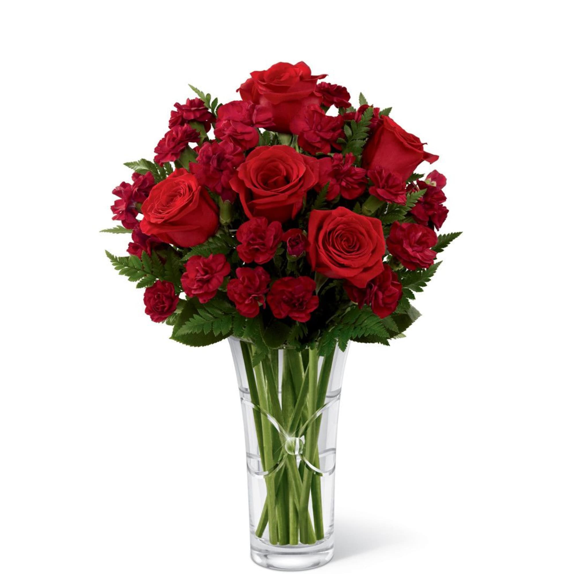 Red roses and carnations arranged in a clear glass vase