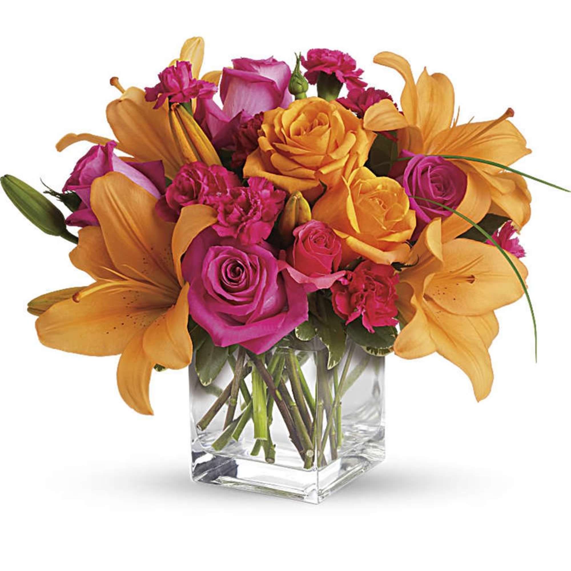 Orange lilies and pink roses arranged in a clear glass vase
