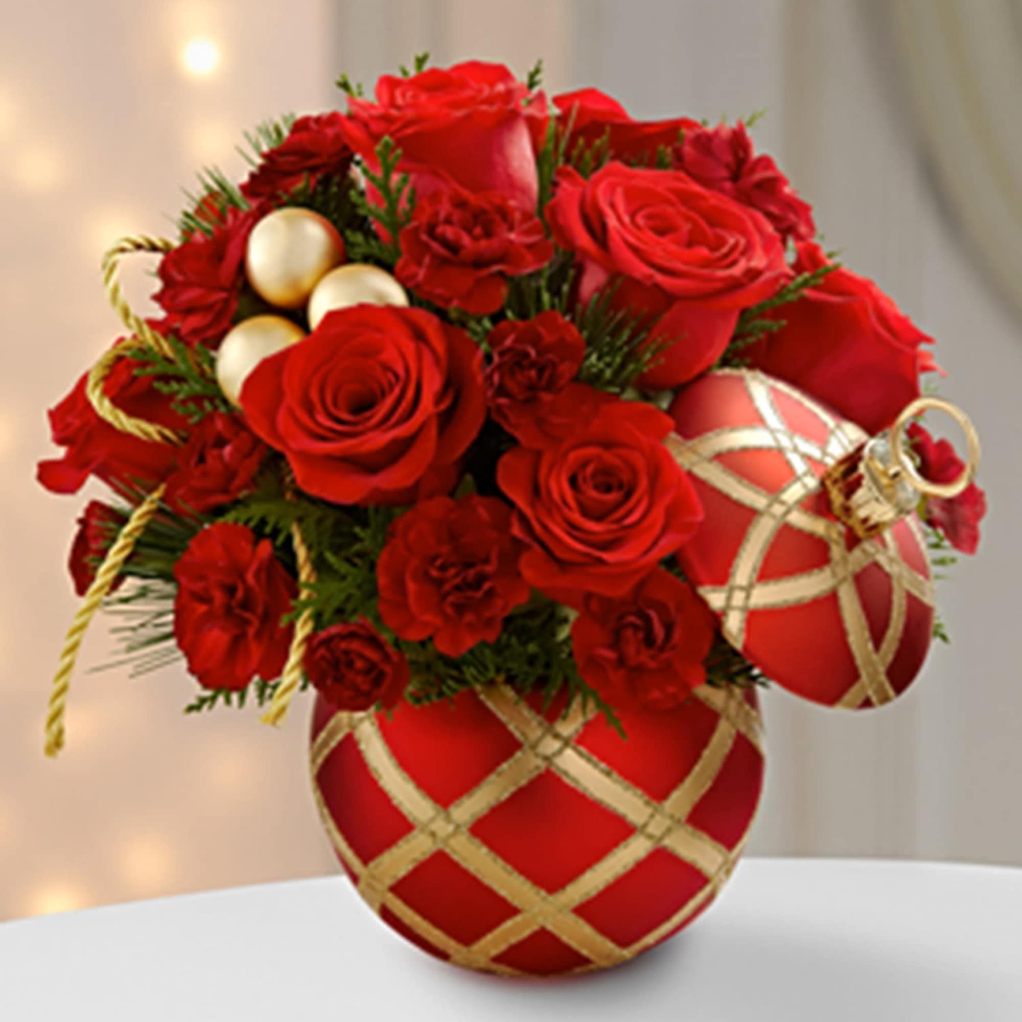 Red roses and carnations arranged in red ornament-shaped containers with gold ribbon accents