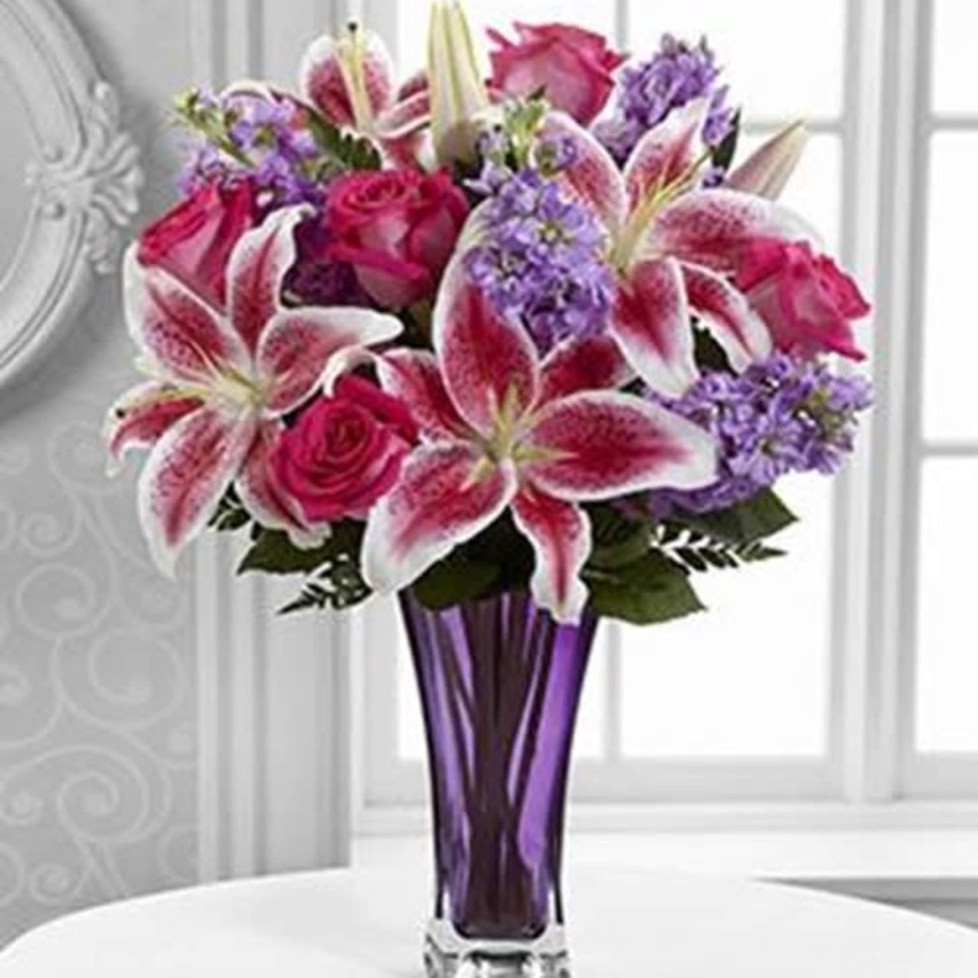 The Timeless Elegance is an enchanting flower arrangement of roses and Stargazer