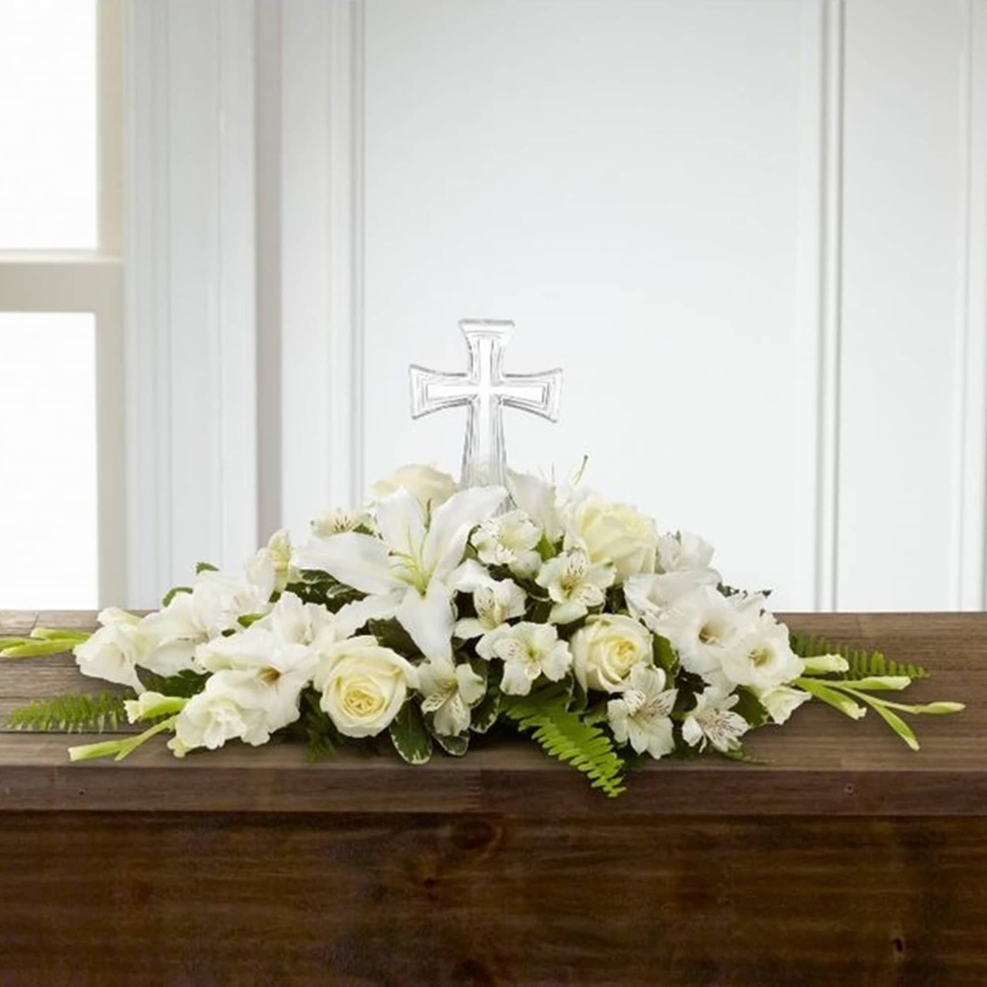 White floral casket spray with a clear cross centerpiece, photo 2 of 2
