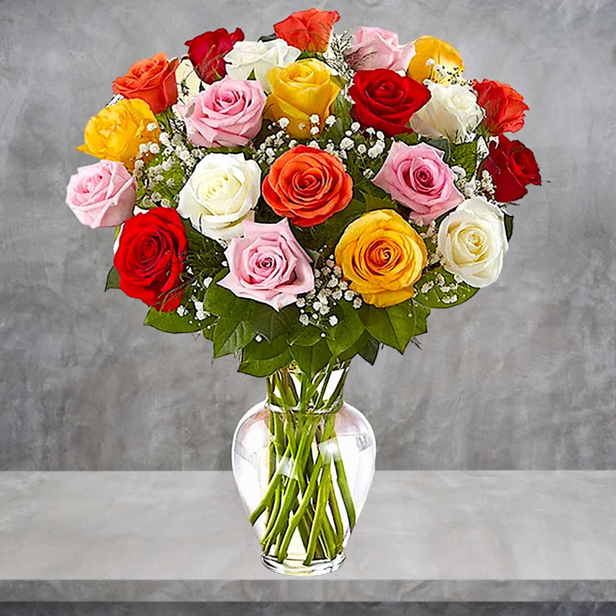 Mixed roses in a clear glass vase