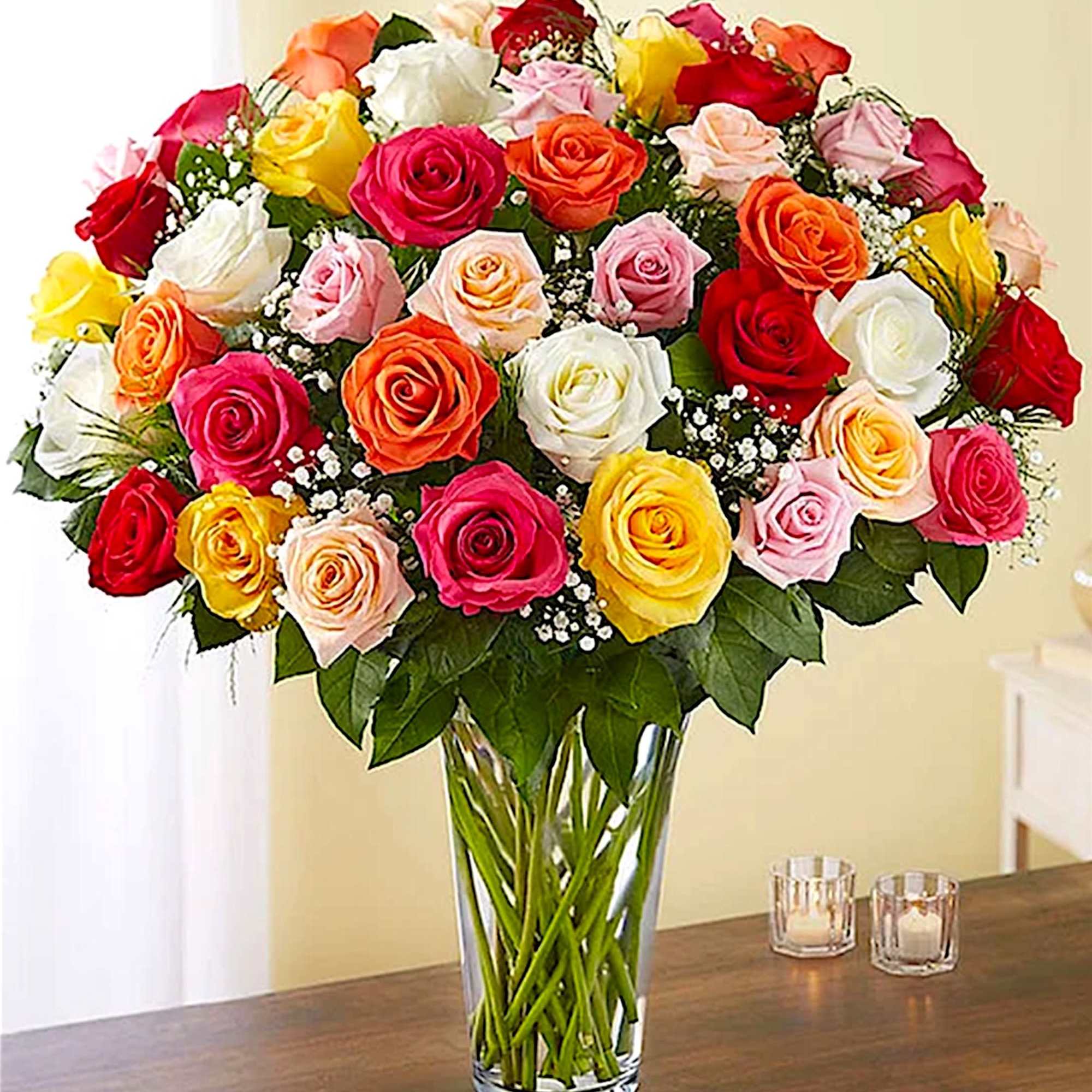 Bouquet of multicolored roses in a clear glass vase