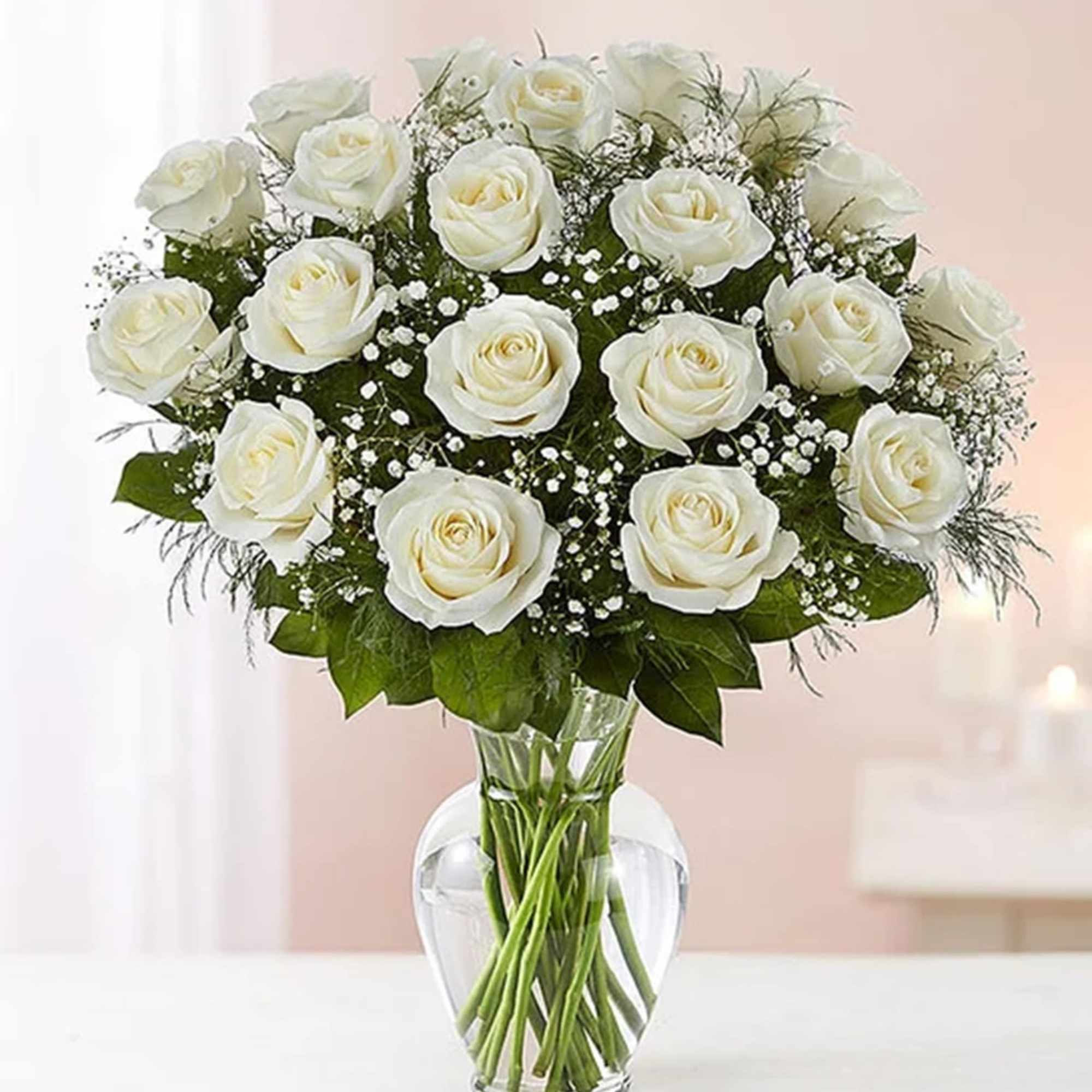 White roses arranged in a clear glass vase