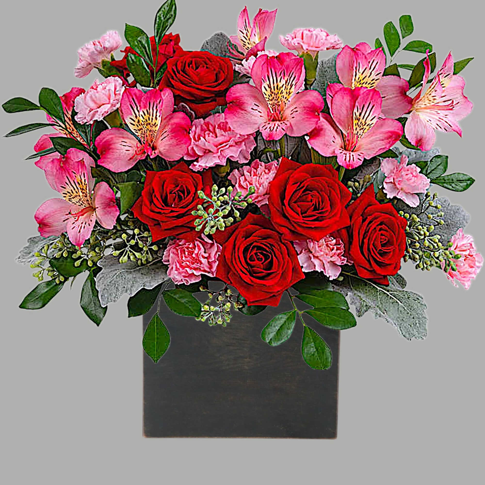 Red roses and pink alstroemeria in a black square vase