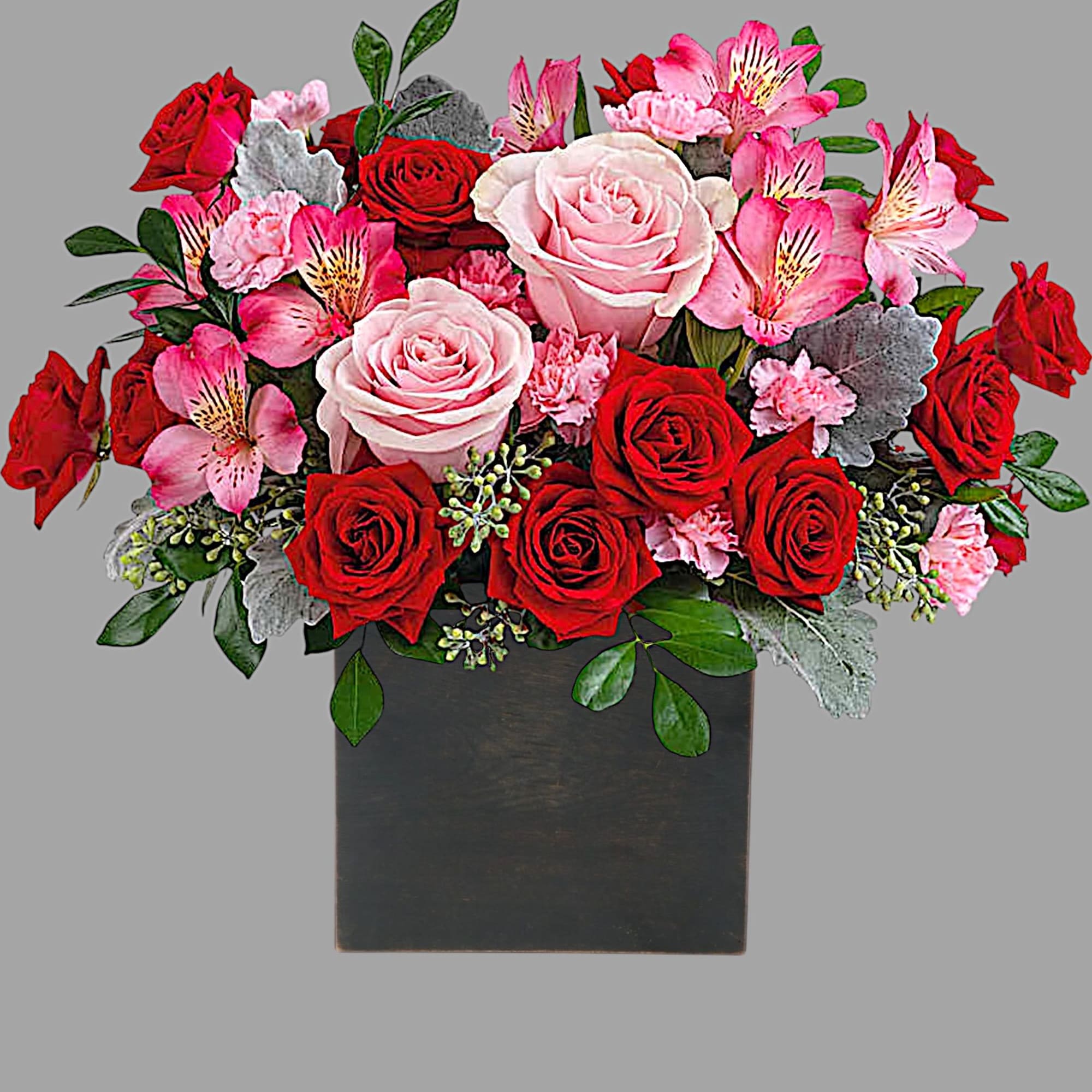 Bouquet of red and pink roses with pink alstroemeria in a black vase